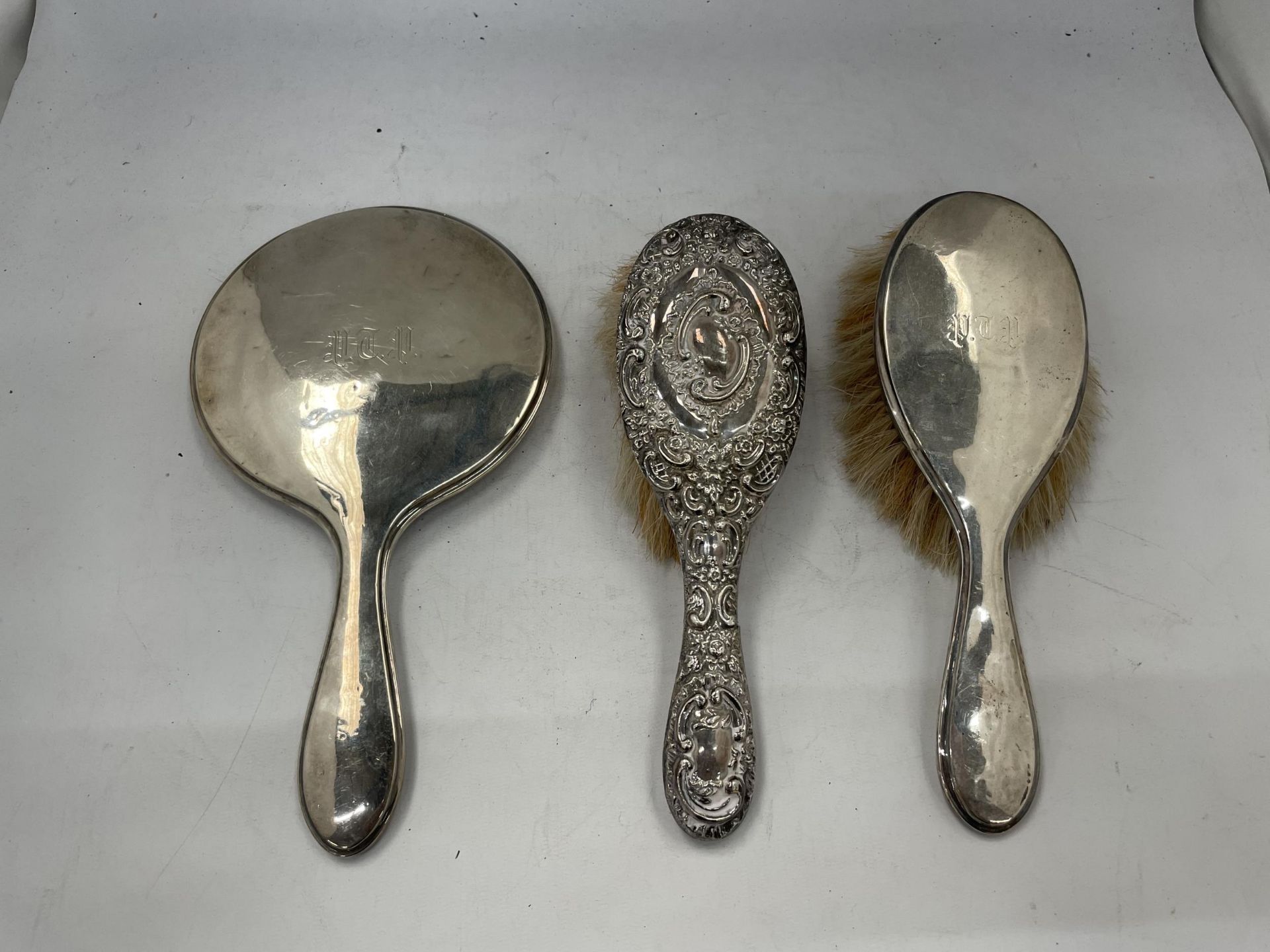 A TWO PIECE HALLMARKED SILVER DRESSING TABLE SET WITH FURTHER HALLMARKED SILVER HAIR BRUSH (3)