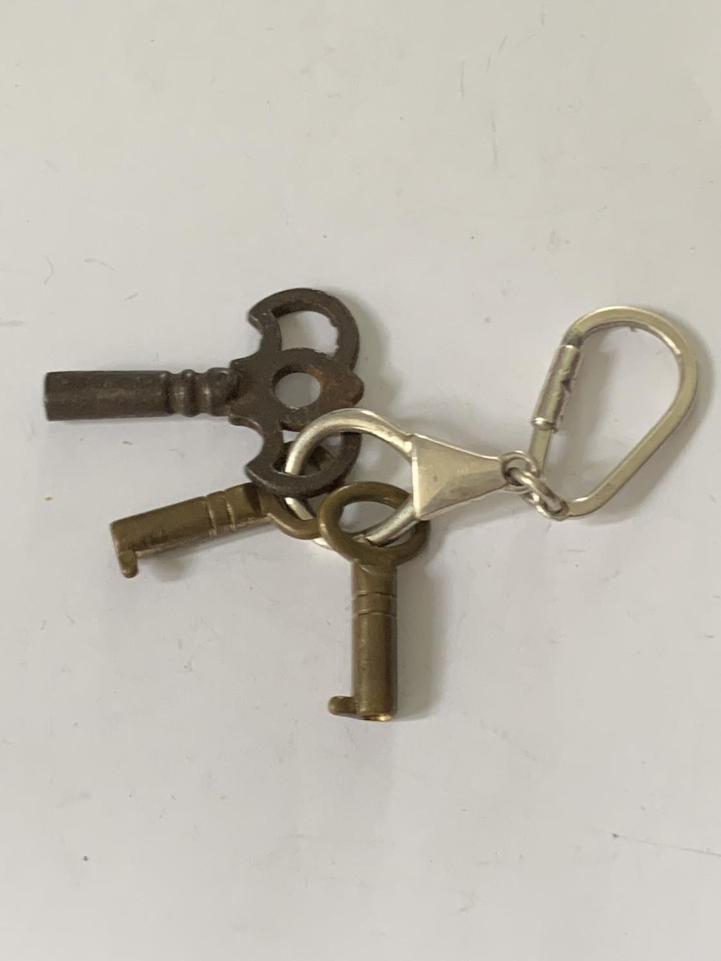 A SILVER KEYRING WITH THREE VINTAGE KEYS - Image 2 of 3