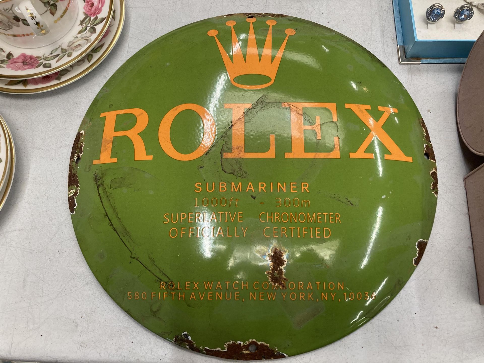 A ROLEX ENAMEL CIRCULAR SIGN