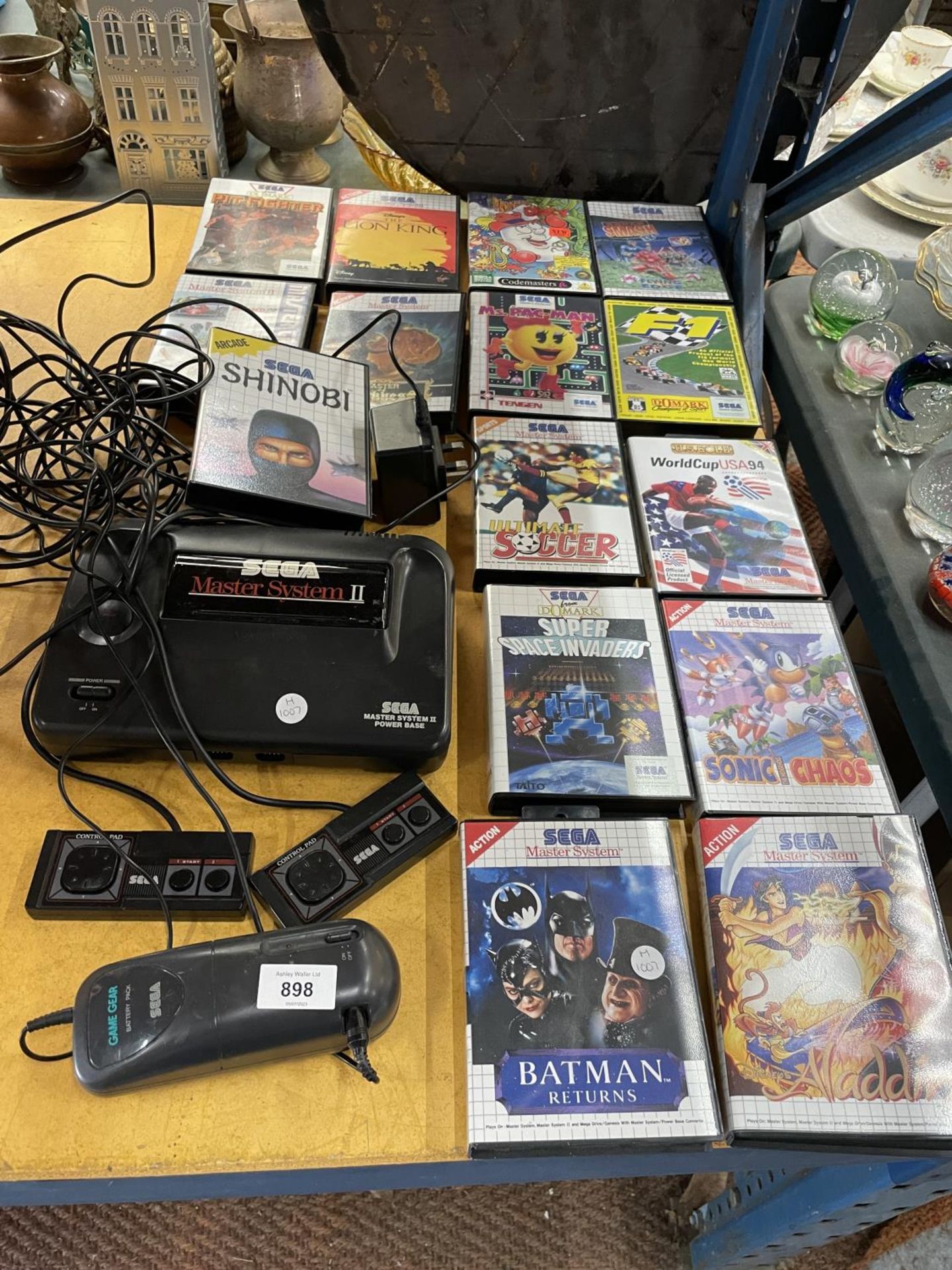 A VINTAGE SEGA MASTER SYSTEM 11 WITH TWO CONTROLLERS PLUS A QUANTITY OF GAMES TO INCLUDE SONIC THE