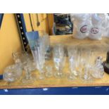 A QUANTITY OF GLASSES TO INCLUDE CHAMPAGNE FLUTES, WINE, TUMBLERS, ETC, PLUS CANDLESTICKS, JUGS,