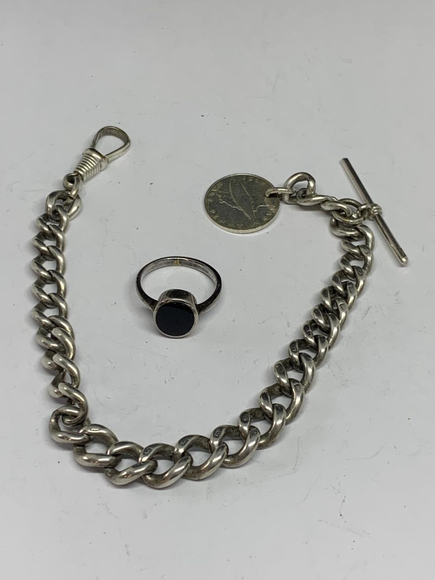 A HEAVY SILVER HALF ALBERT WATCH CHAIN WITH A 1976 ISLE OF MAN HALF PENNY AND A SILVER RING WITH