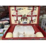 A VINTAGE 'SIRRAM' PICNIC HAMPER WITH FLASKS, SNADWICH BOXES, CUPS, PLATES AND CUTLERY
