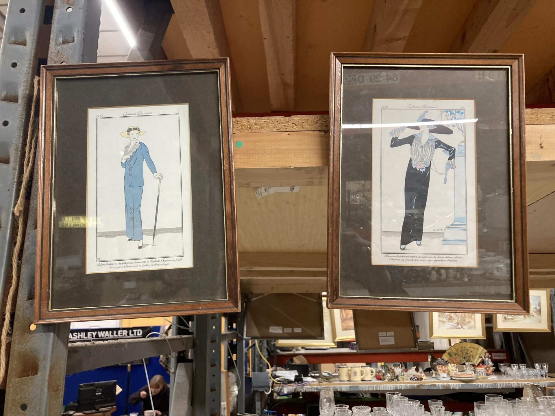 A PAIR OF FRAMED ART DECO STYLE FRENCH PRINTS