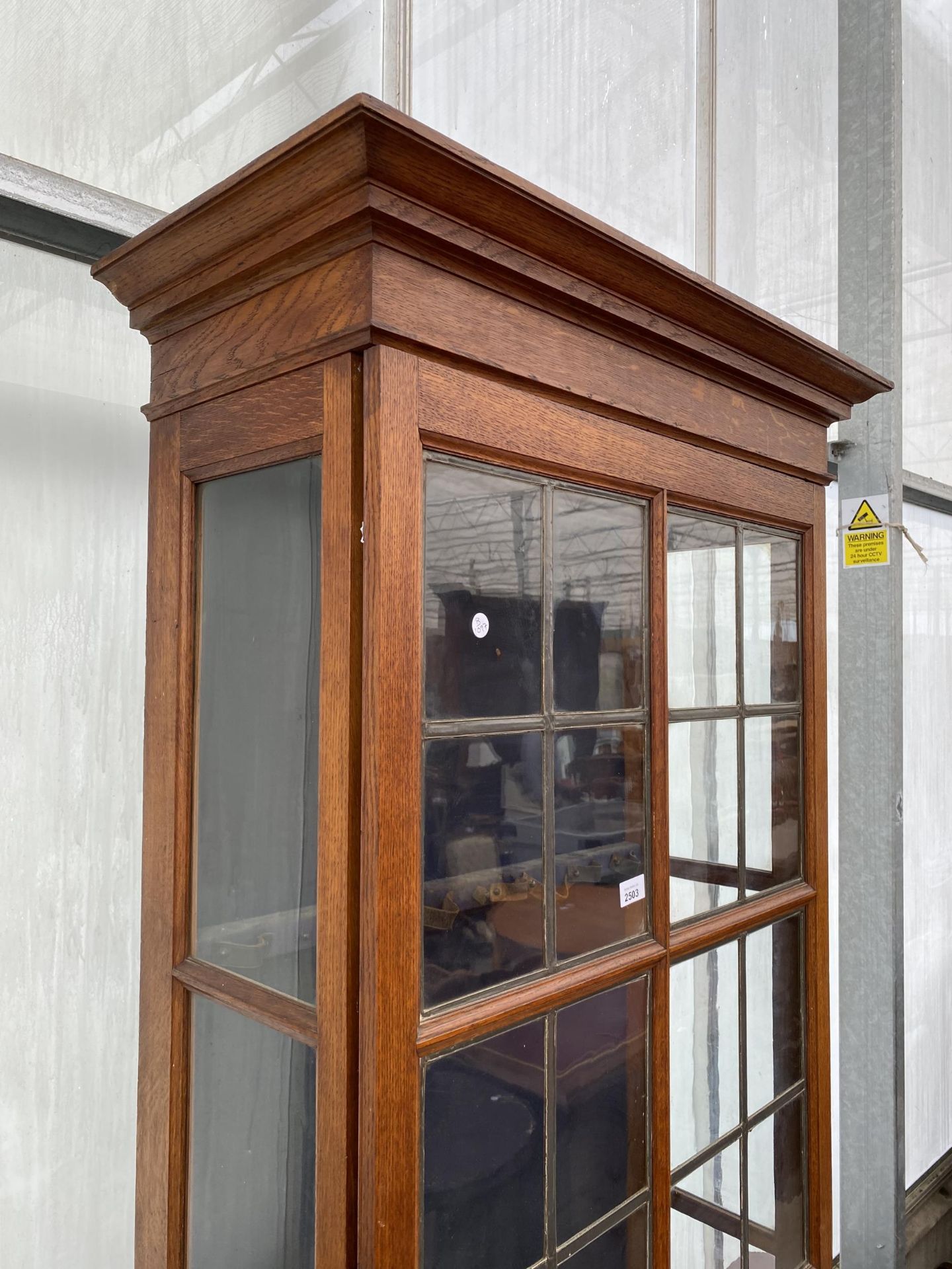 AN EARLY 20TH CENTURY OAK GLAZED AND LEADED GUN CABINET WITH STEPPED INTERNAL SHELVES AND DRAWERS, - Image 2 of 6