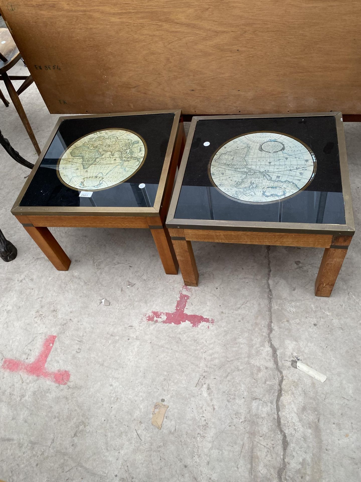 A PAIR OF LOW LAMP TABLES, THE TOPS INSET WITH WORLD MAPS, 18" SQUARE, WITH BRASS EDGES