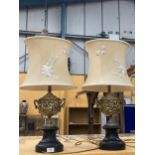 A PAIR OF DECORATIVE METAL TABLE LAMPS WITH CLASSICAL DESIGN