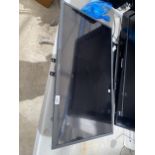 A SAMSUNG 32" TELEVISION WITH STAND AND WALL MOUNTING BRACKET