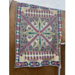 A DECORATIVE COLOURFUL PATTERNED WOVEN WALL HANGING