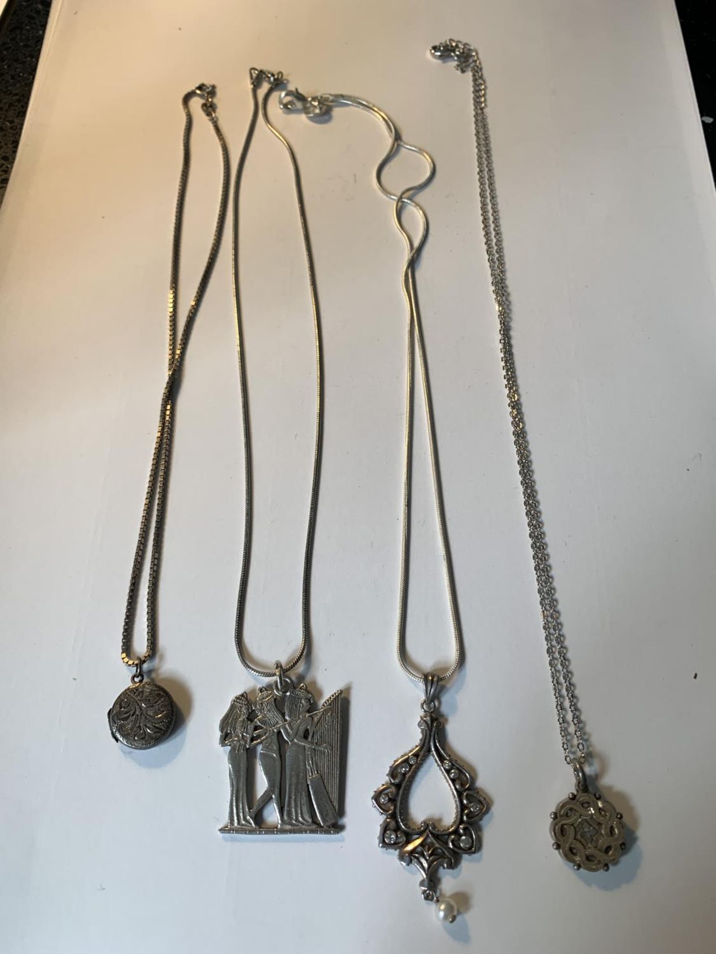 FOUR SILVER NECKLACES WITH PENDANTS