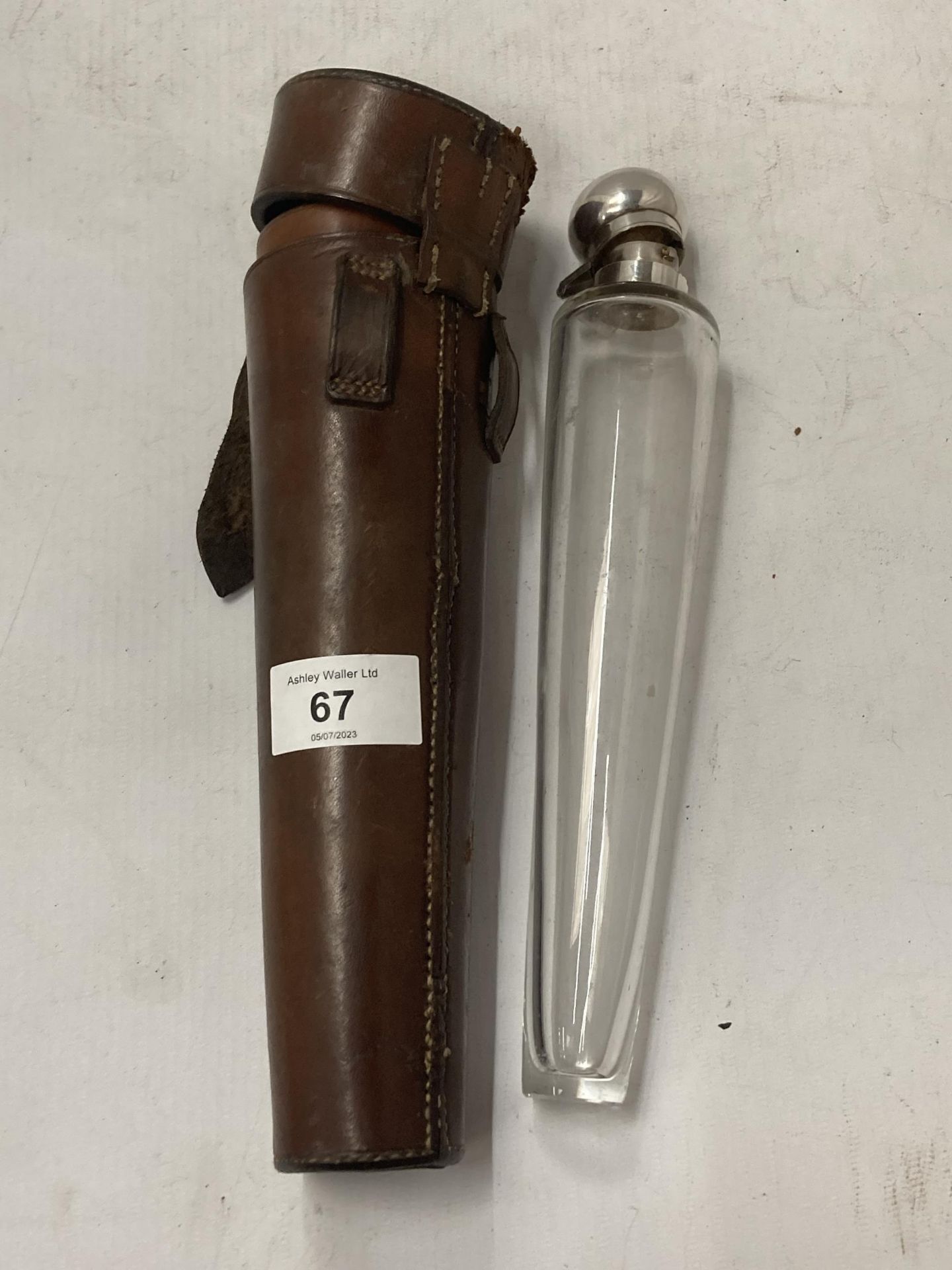 A VINTAGE LEATHER CASE WITH HUNTING GLASS VIAL WITH WHITE METAL TOP