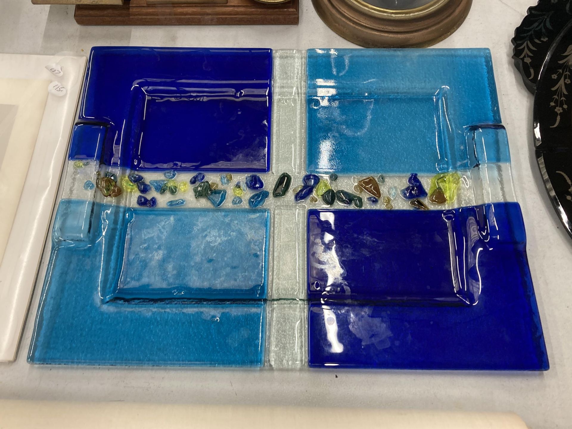 A STUDIO GLASSWARE TRAY MADE IN TWO SHADES OF BLUE WITH GLASS 'PEBBLES'