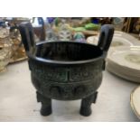 AN ORIENTAL WOODEN TWIN HANDLED ARCHAIC DESIGN PLANTER