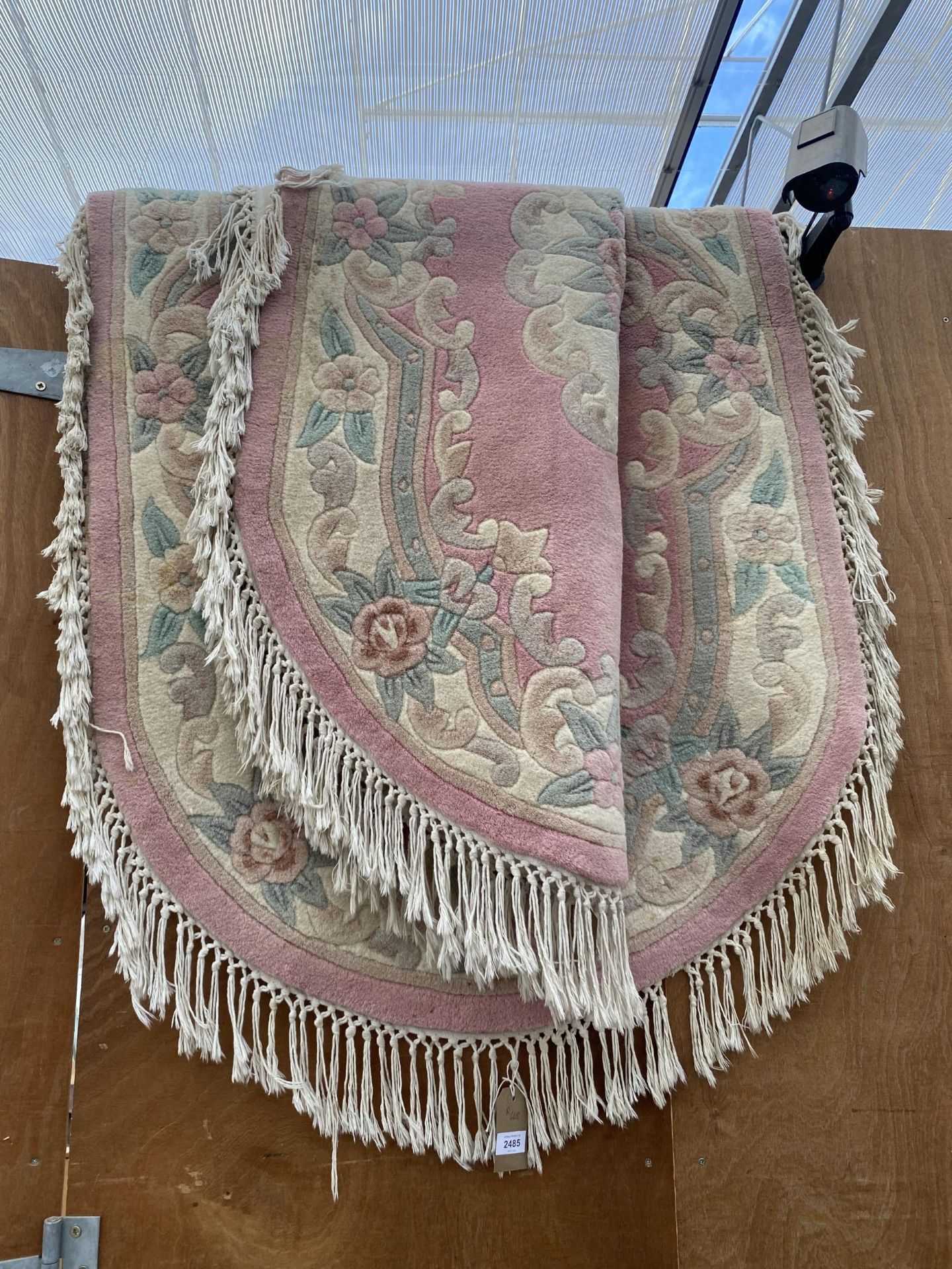 TWO PINK PATTERNED OVAL FRINGED RUGS