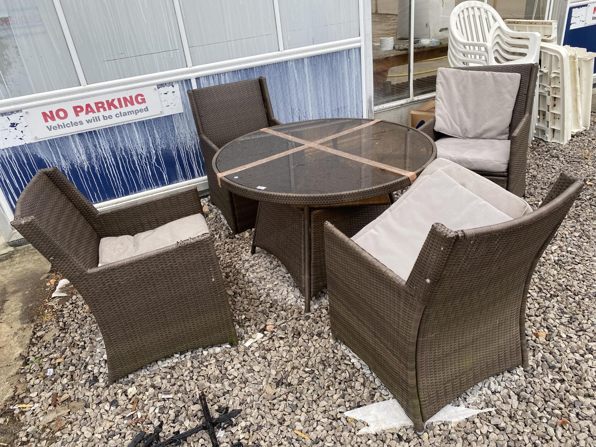 A RATTAN PATIO FURNITURE SET COMPRISING OF A ROUND TABLE AND FOUR CHAIRS