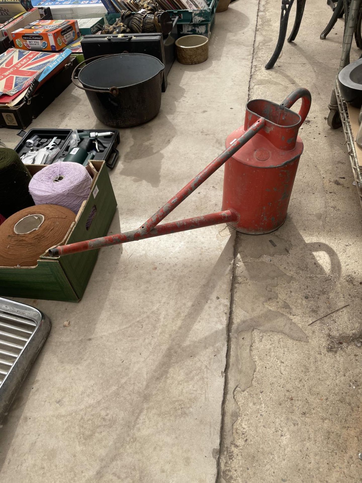 A VINTAGE RED PAINTED AND GALVANISED HAWS WATERING CAN