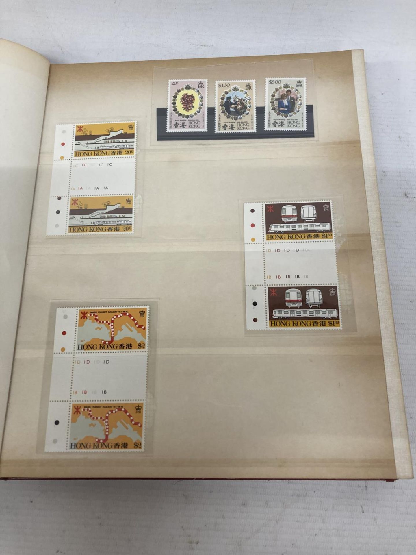 HONG KONG , RED STOCK BOOK HOUSING UNMOUNTED MINT RANGES OF COMMEMORATIVES AND DEFINITIVES ,