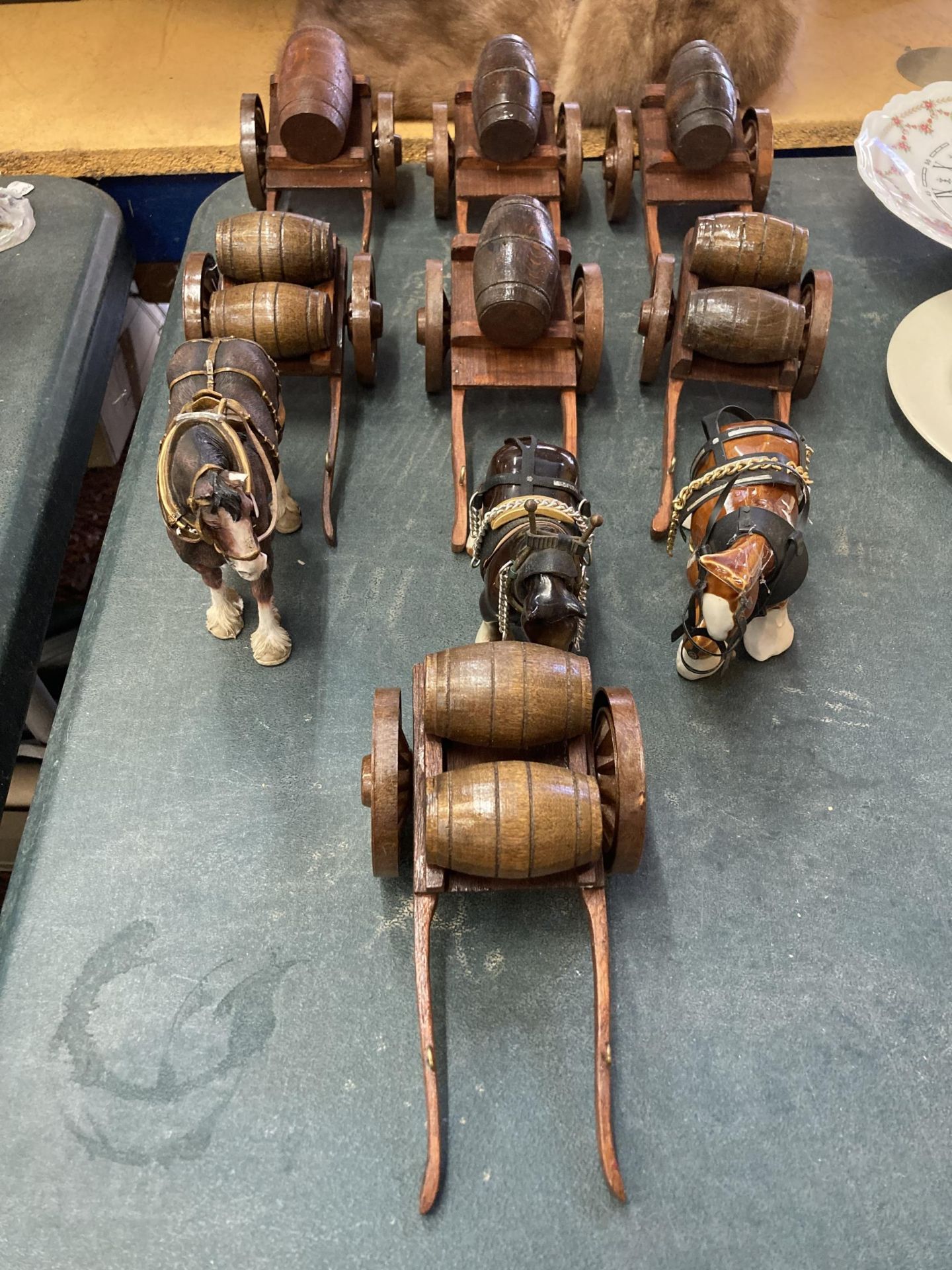 A GROUP OF SHIRE HORSE MODELS WITH WOODEN CARTS