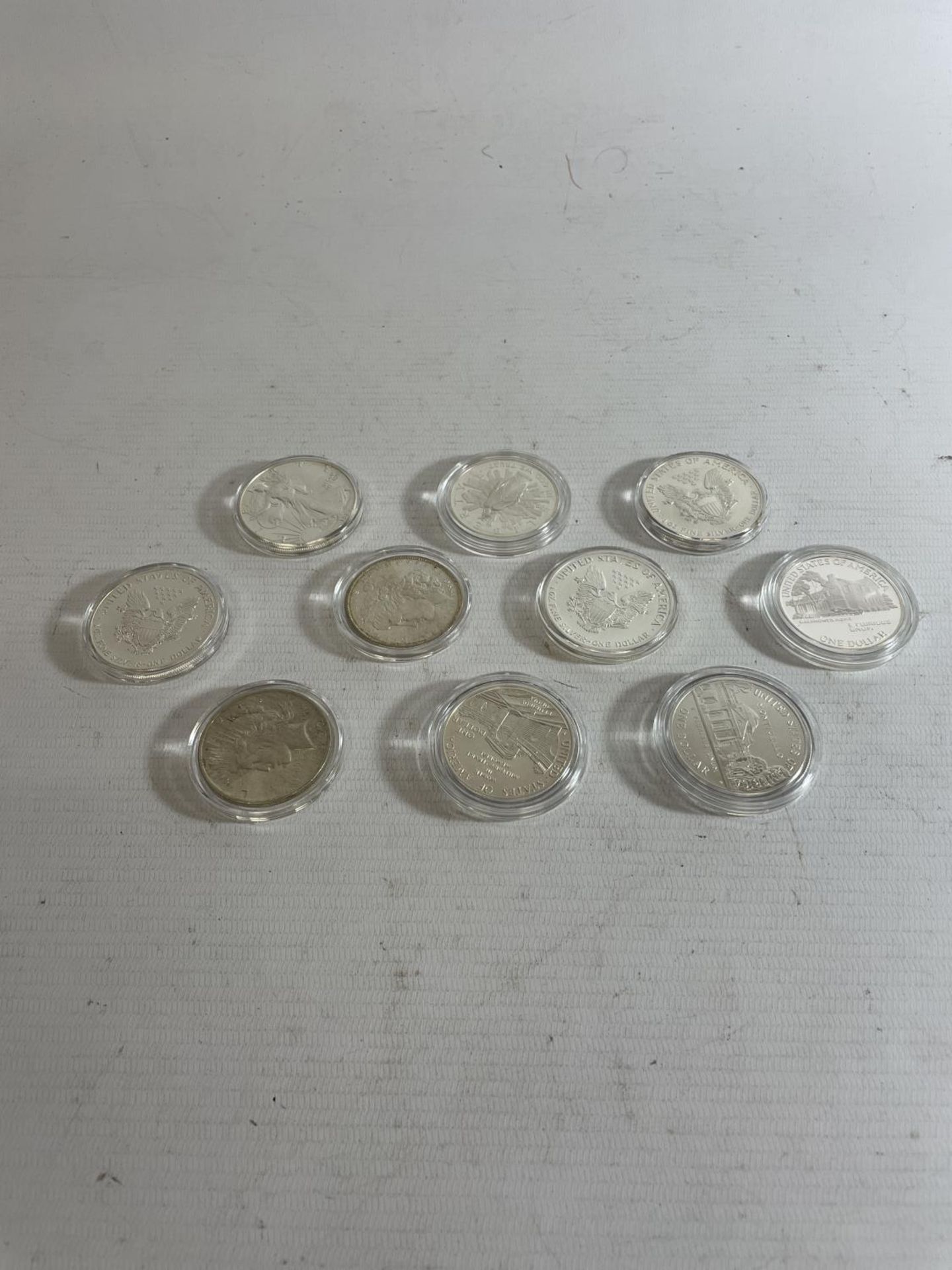 A SELECTION OF 10 USA SILVER $1 COINS , EACH ENCAPSULATED , DATED : 1890, 1922, 1987-8 , 1989 X 2,