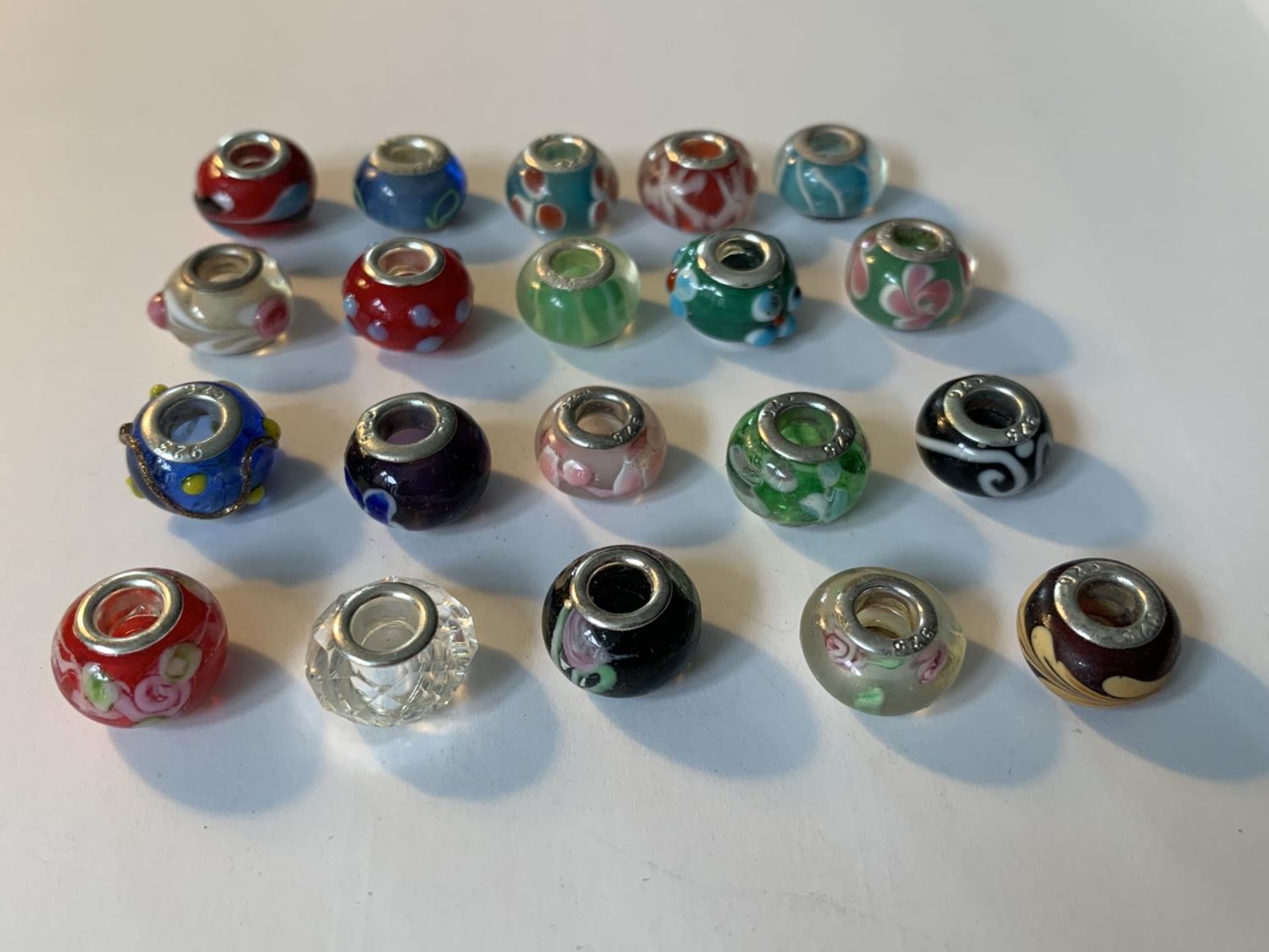 TWENTY SILVER RIMMED MURANO BEADS