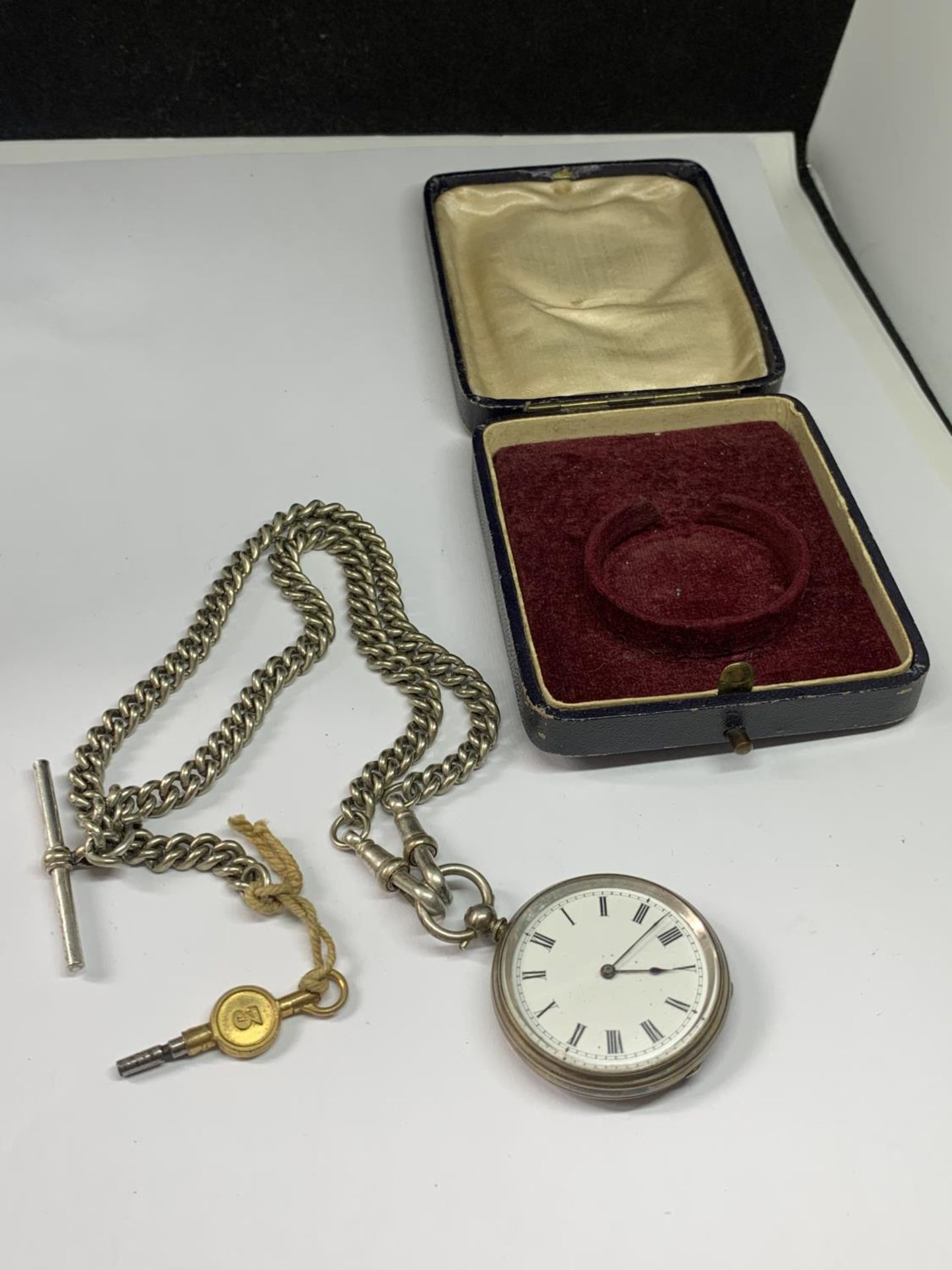 A SILVER POCKET WATCH WITH ALBERT CHAIN AND KEY IN A PRESENTATION BOX