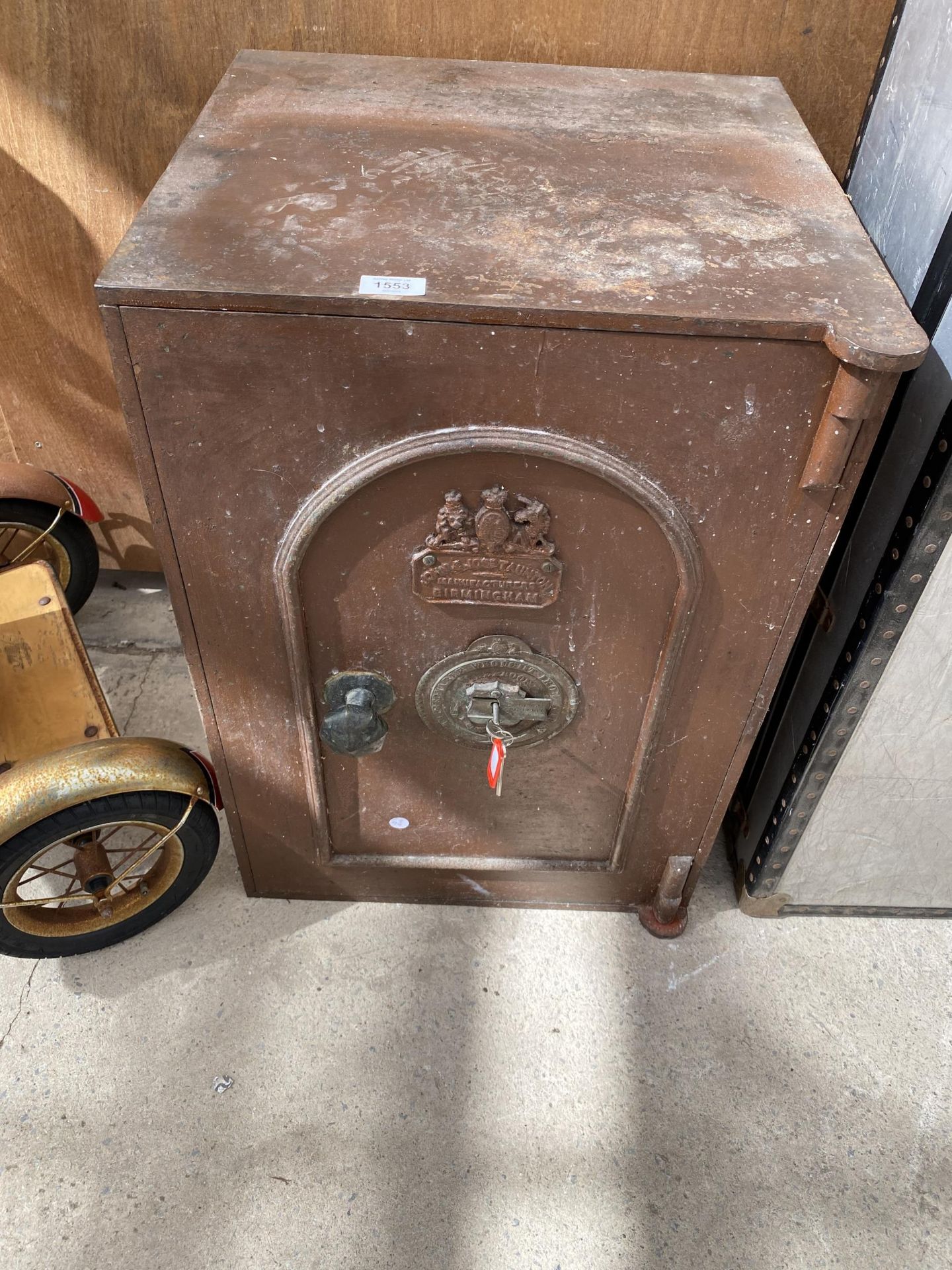 A VINTAGE SAFE WITH KEY BEARING THE NAME PLAQUE 'JOHN AND JOS TAUNTON' BIRMINGHAM