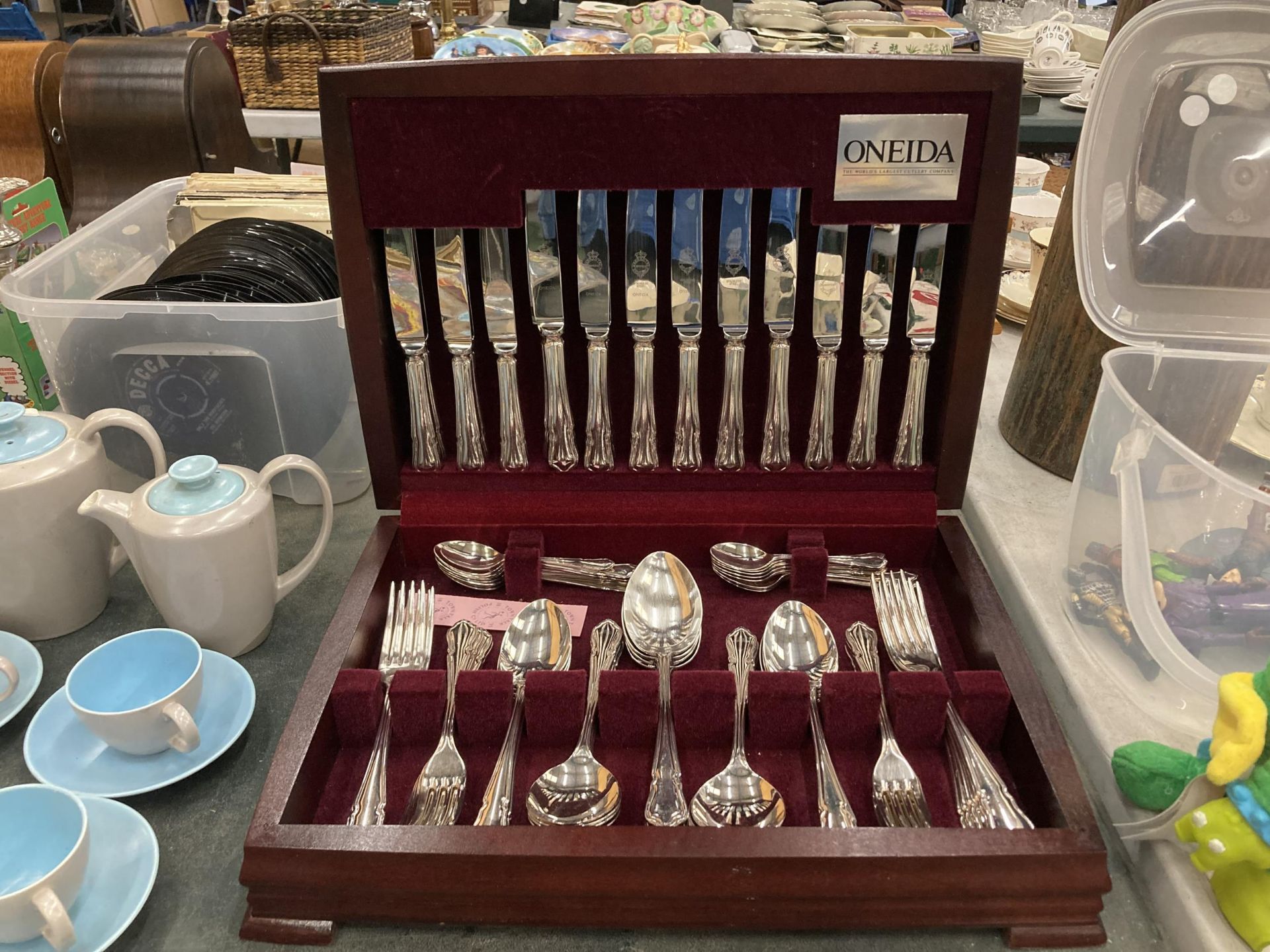 AN ONEIDA CANTEEN OF CUTLERY IN A WOODEN BOX