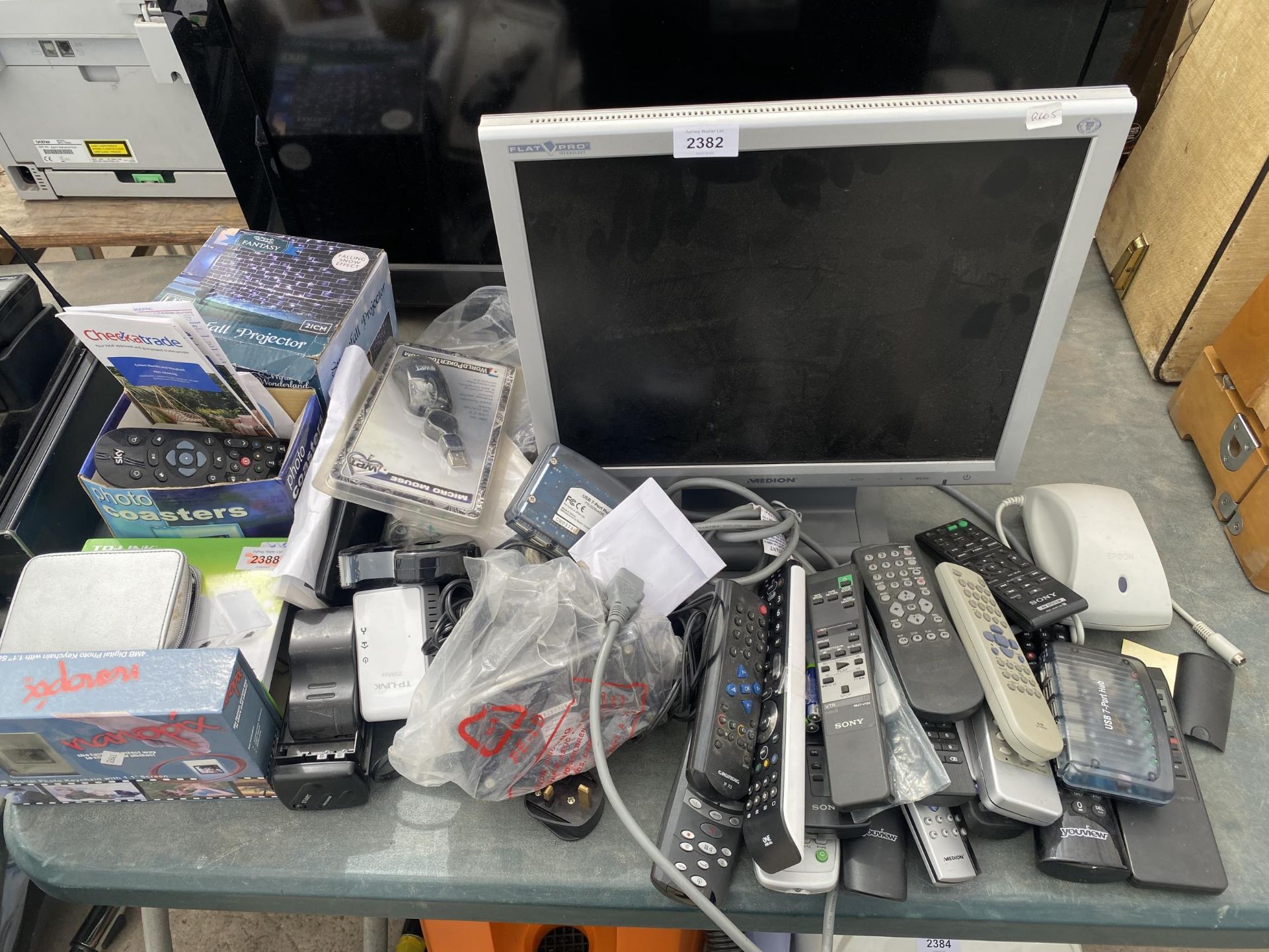 A LARGE ASSORTMENT OF ITEMS TO INCLUDE A MONITOR AND REMOTE CONTROLS ETC