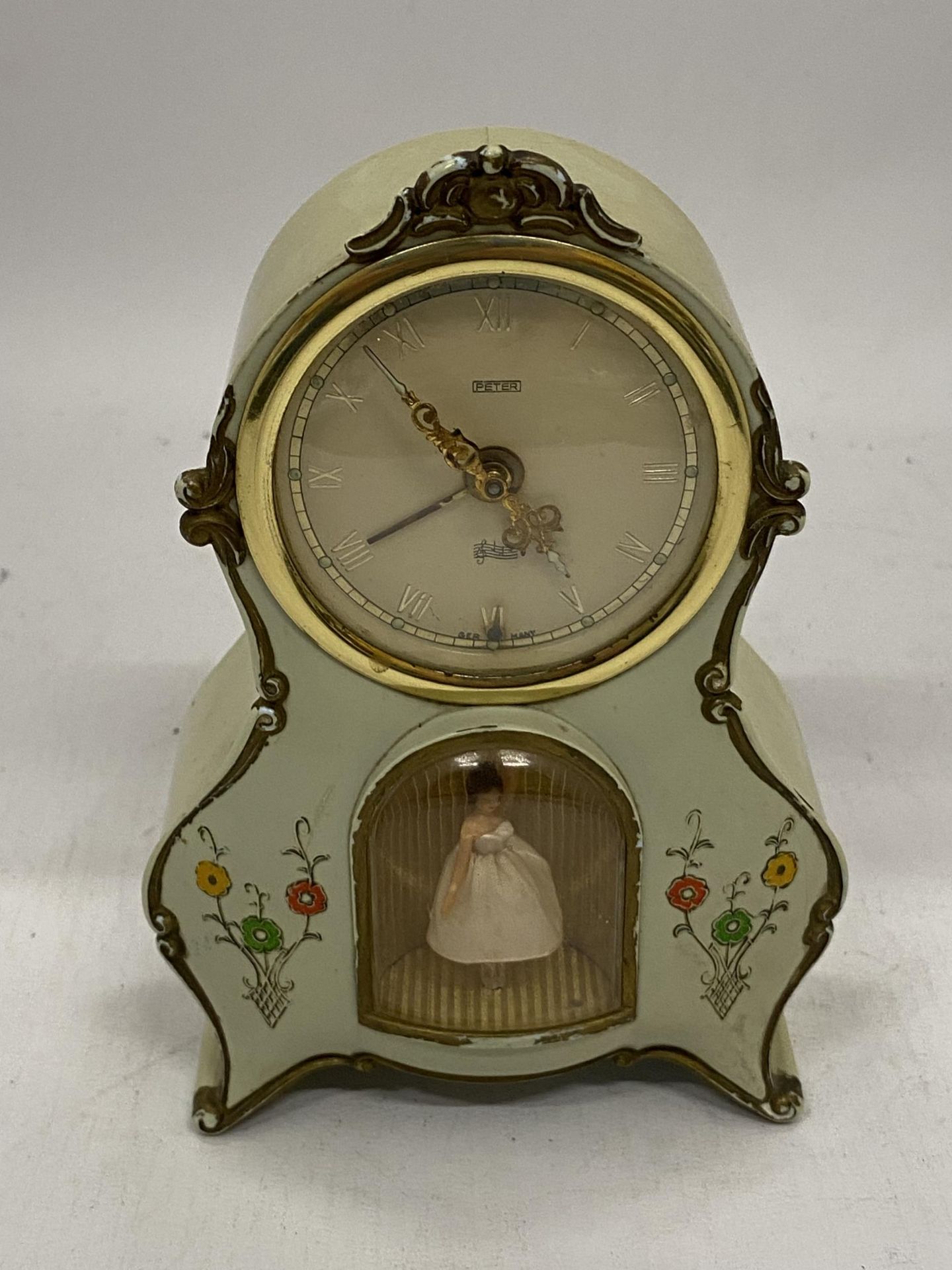 A VINTAGE MANTLE CLOCK WITH AN INSET DANCING BALLERINA