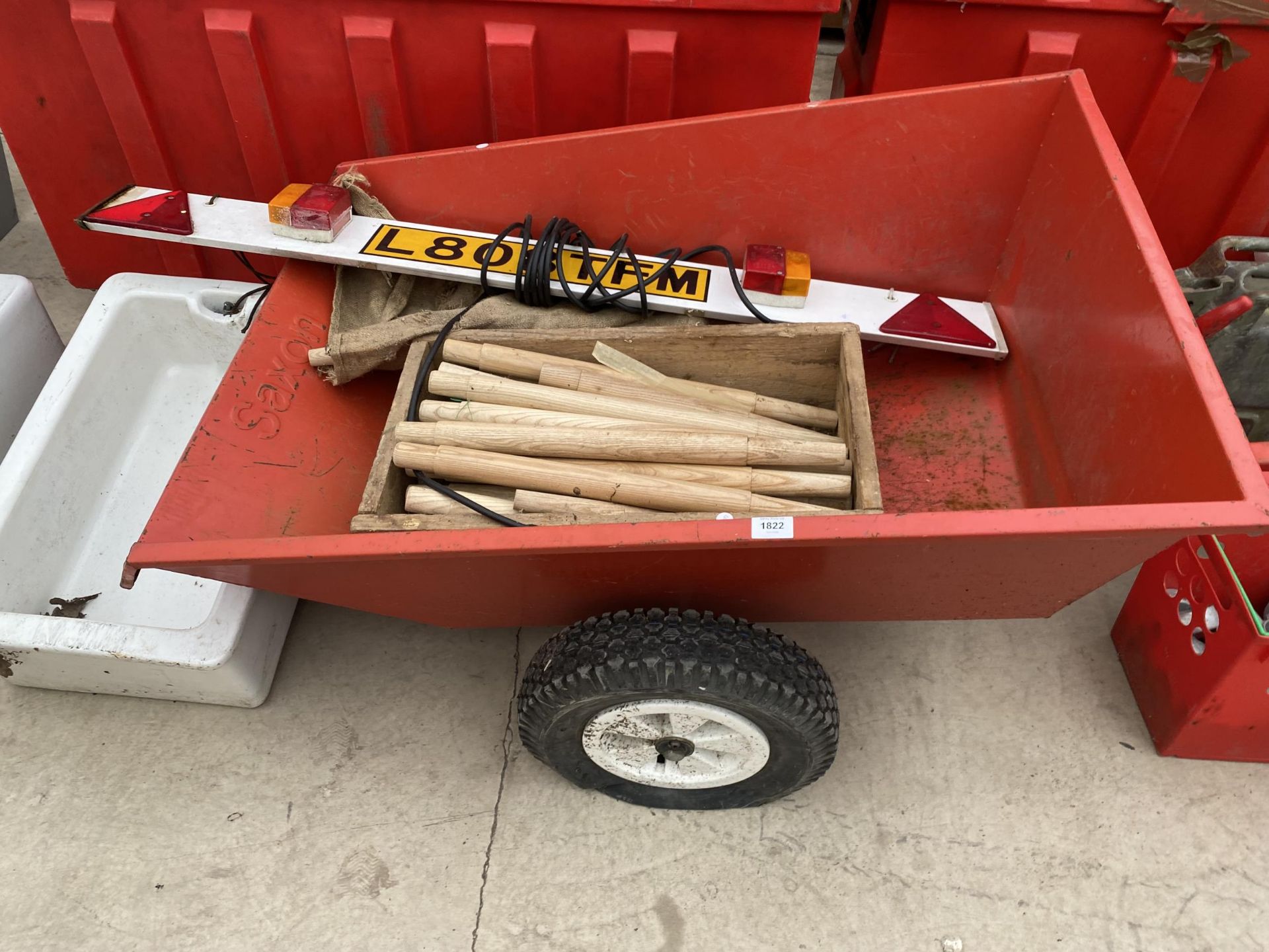 A TWO WHEELED GARDEN TRAILER, A LIGHT BOARD AND SHOVEL HANDLES