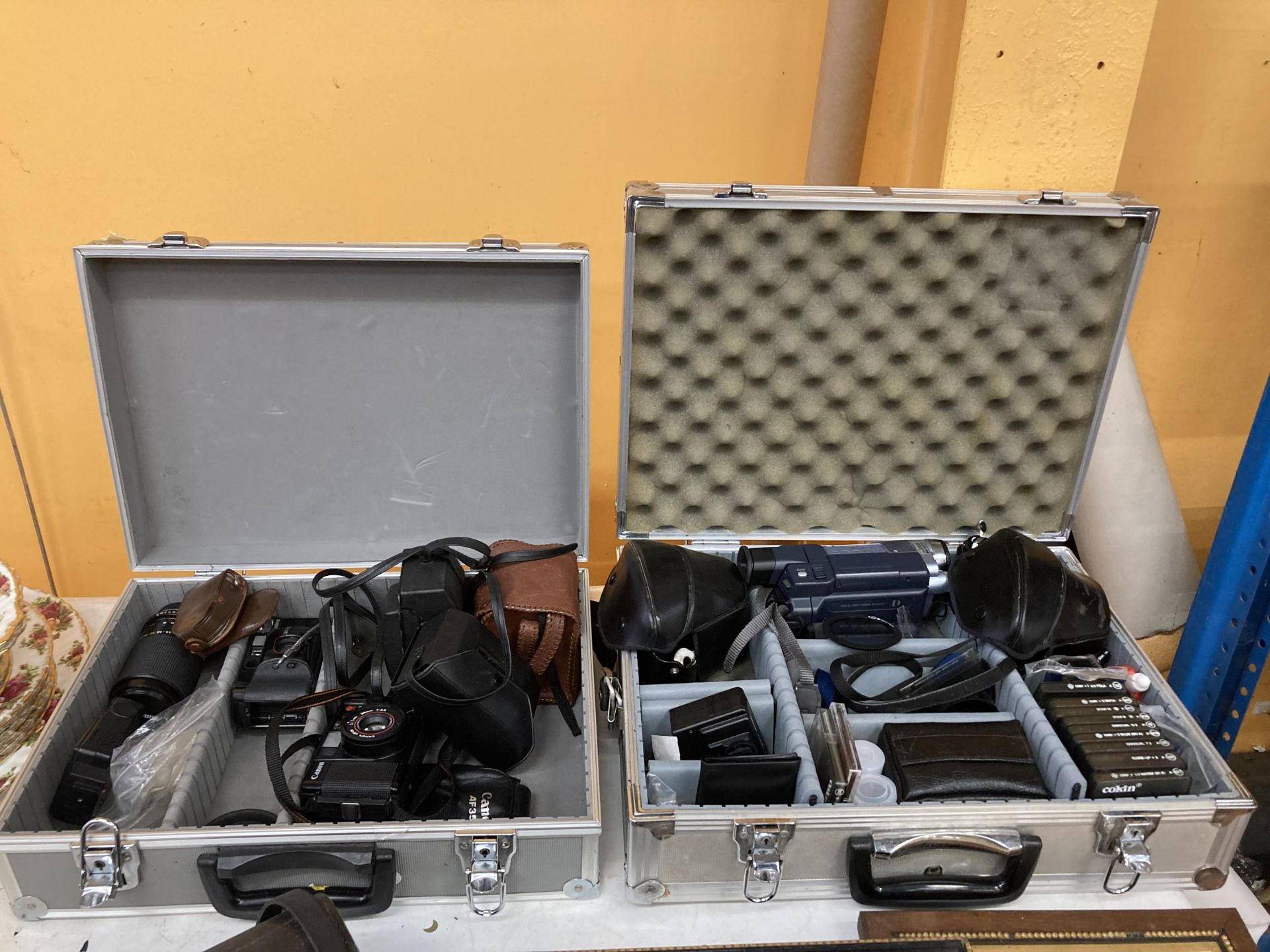 TWO CASES CONTAINING ASSORTED CAMERAS AND ACCESSORIES, CANON, SONY CAM CORDER ETC