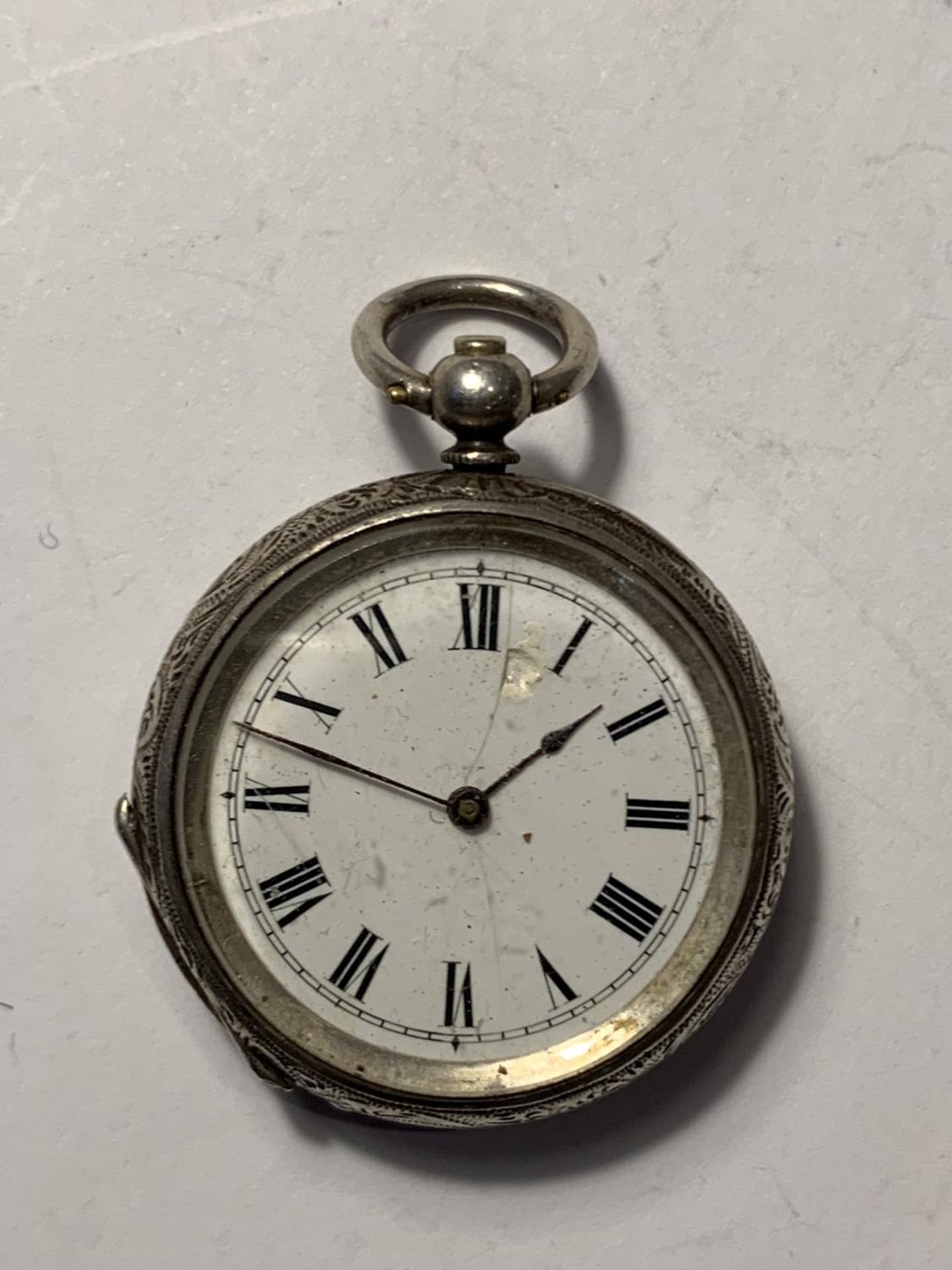 AN ORNATE LADIES SILVER POCKET WATCH