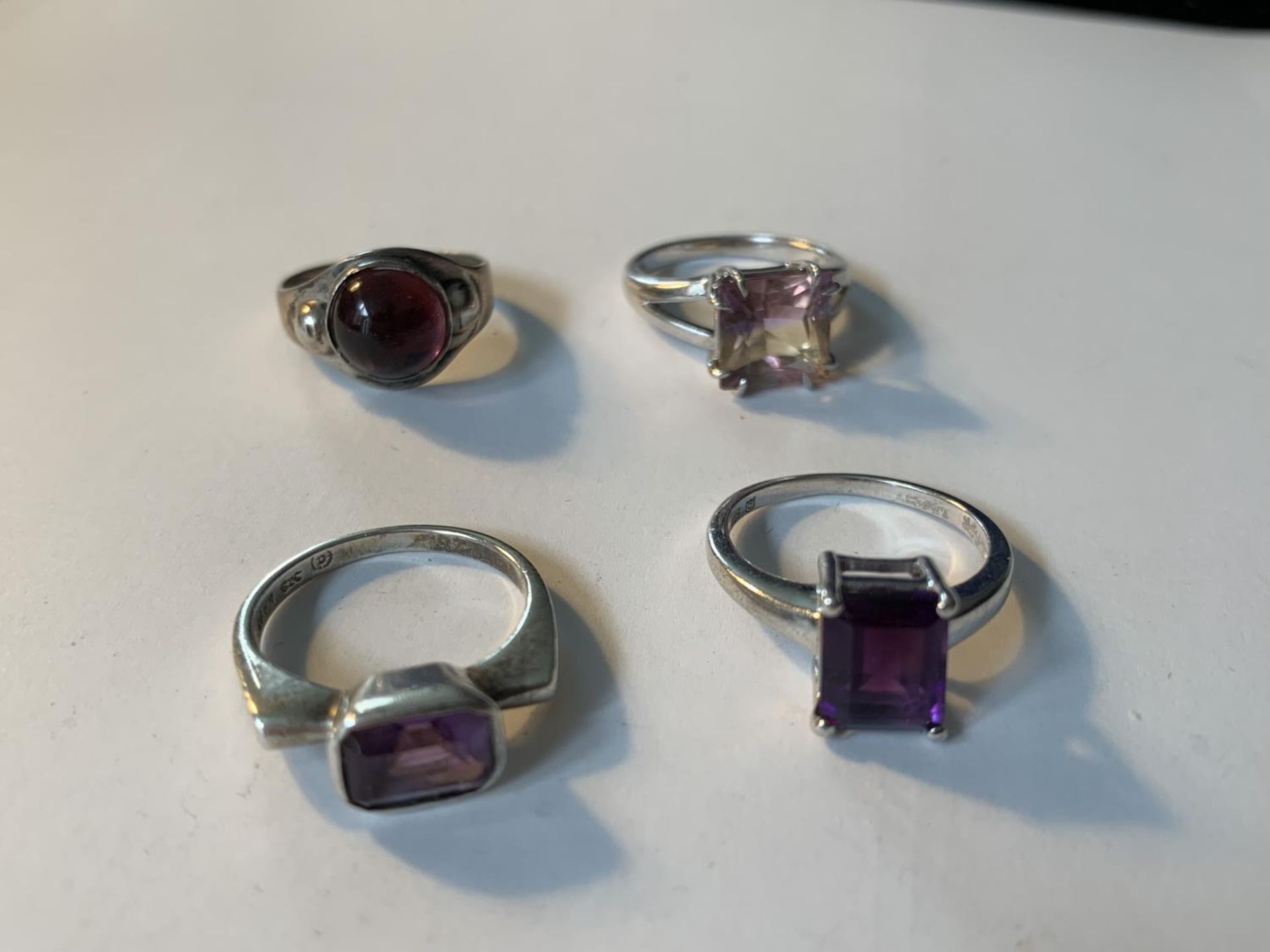 FOUR VARIOUS SILVER RINGS