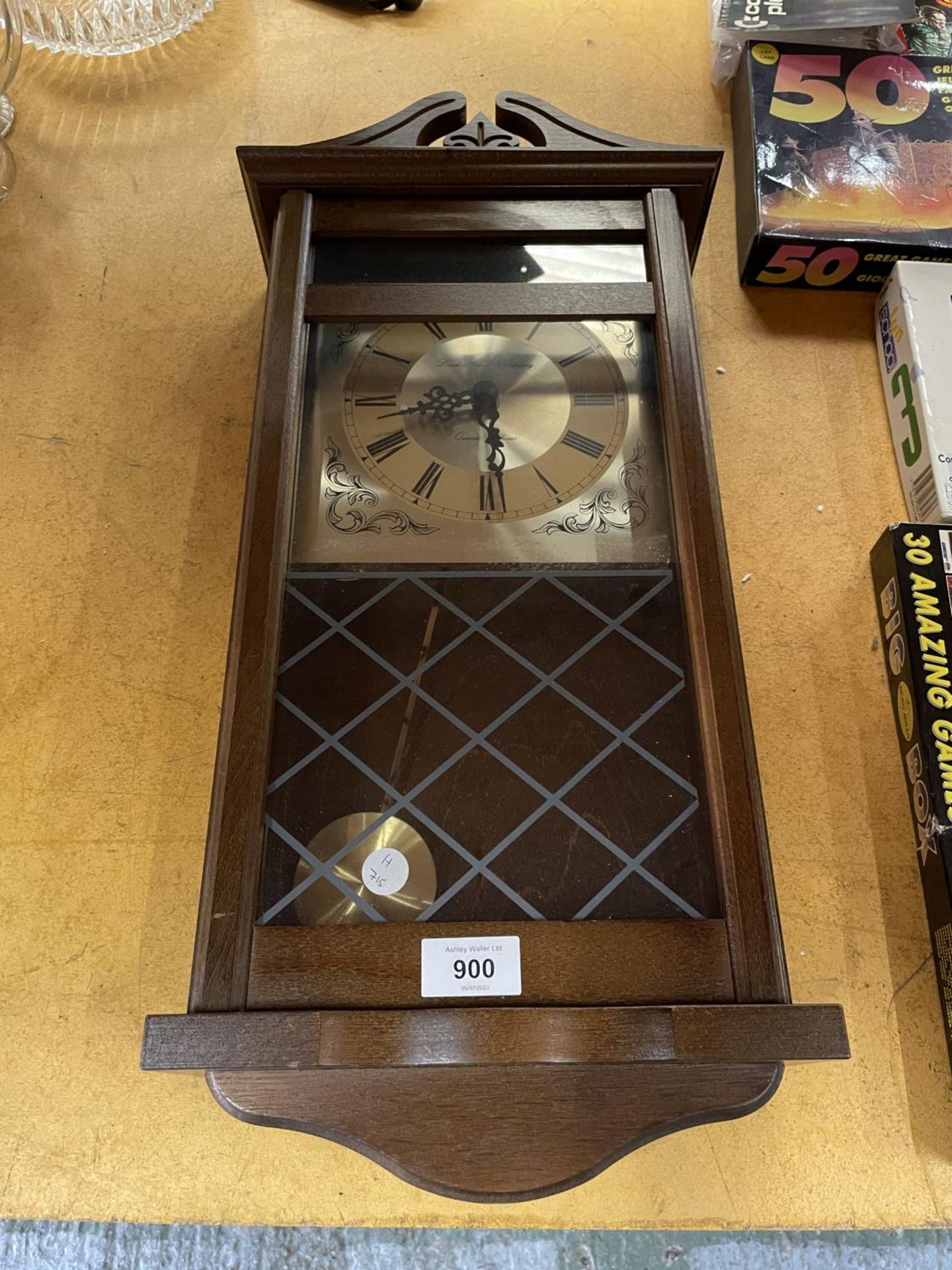 A VINTAGE STYLE MAHOGANY WALL CLOCK WITH PENDULUM