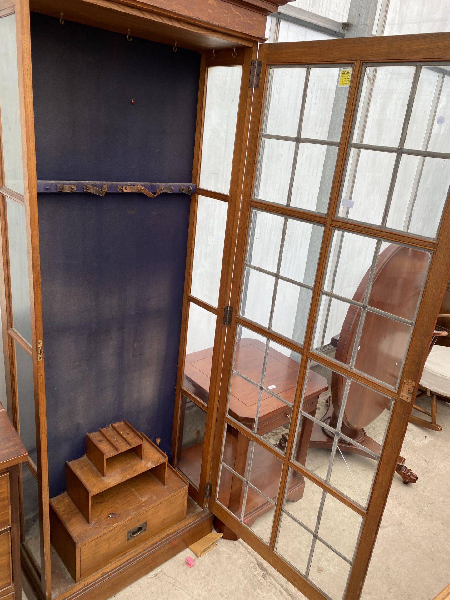 AN EARLY 20TH CENTURY OAK GLAZED AND LEADED GUN CABINET WITH STEPPED INTERNAL SHELVES AND DRAWERS, - Image 3 of 6