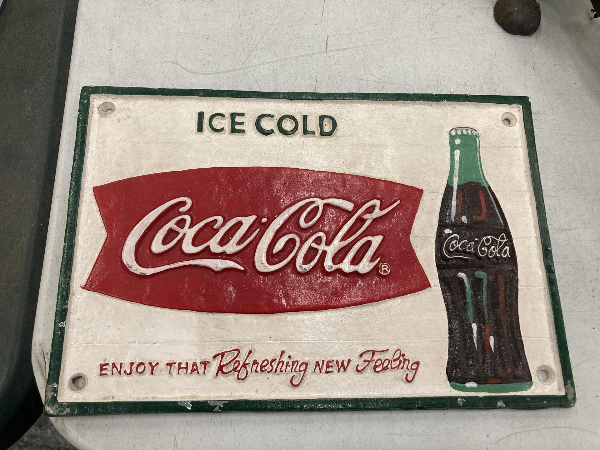 A CAST COCA COLA SIGN