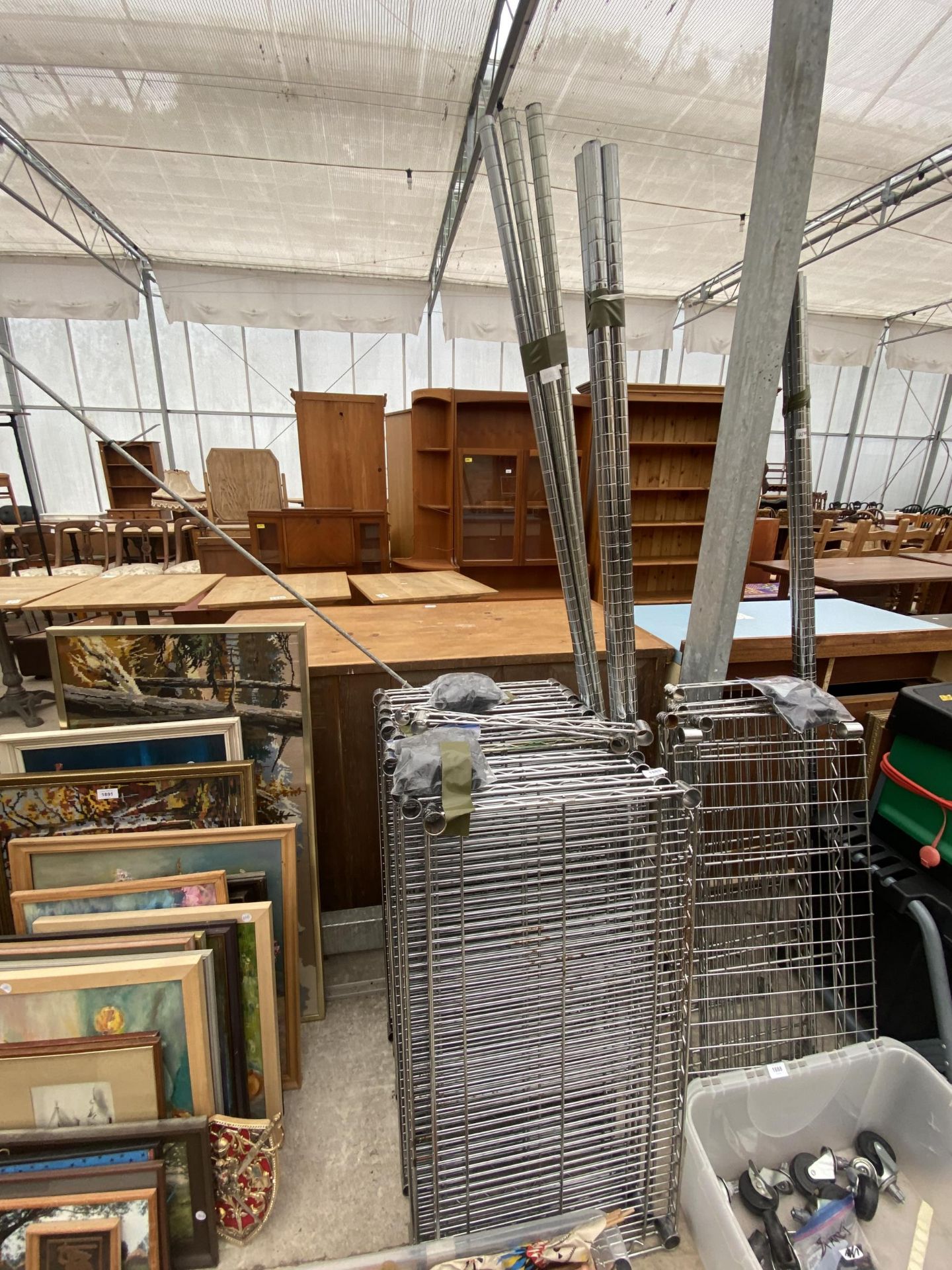 AN ASSORTMENT OF METAL SHELVING UNITS WITH WHEELED BASE