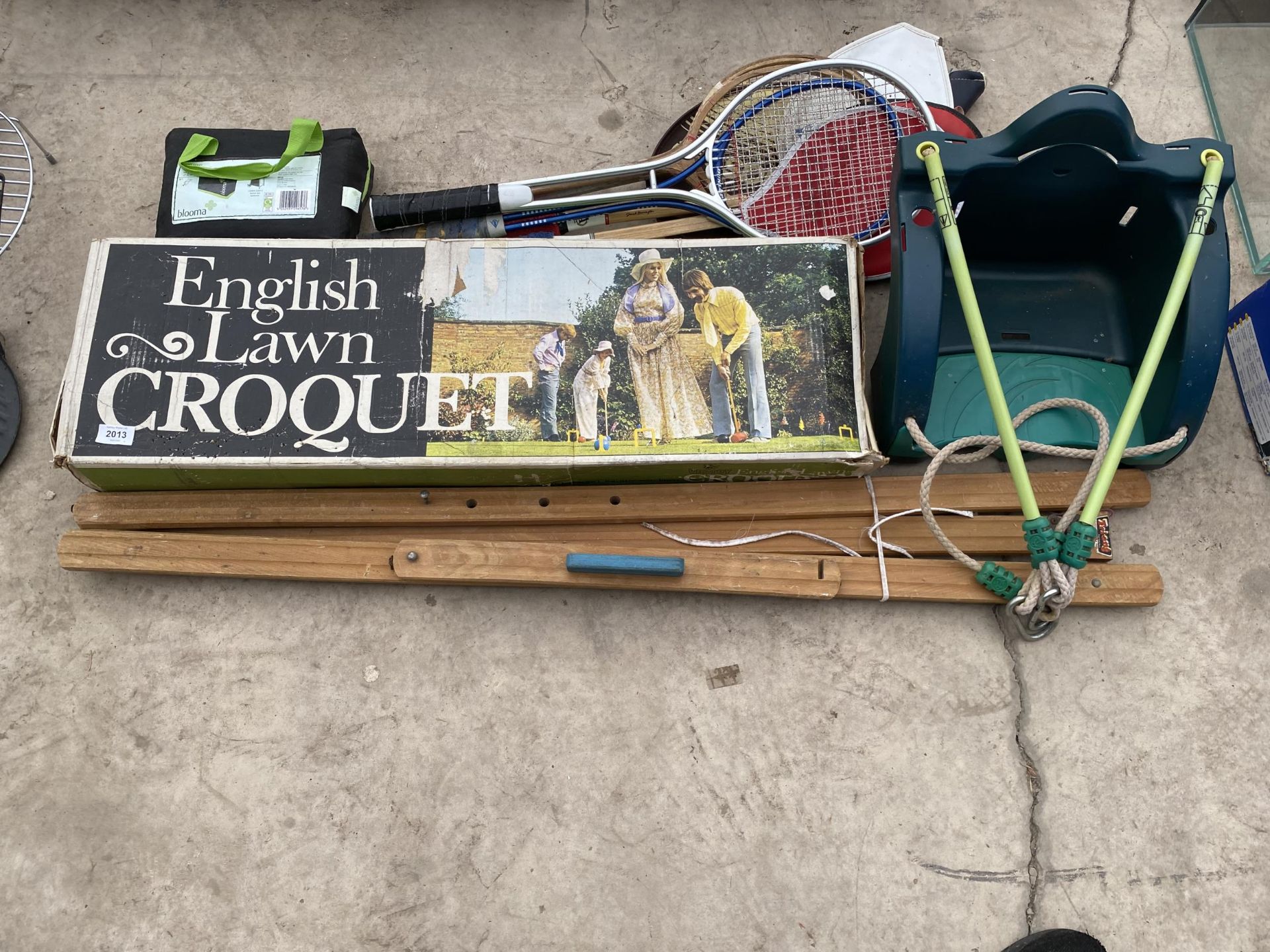 AN ASSORTMENT OF SPORTS EQUIPMENT TO INCLUDE TENNIS RACKETS ETC