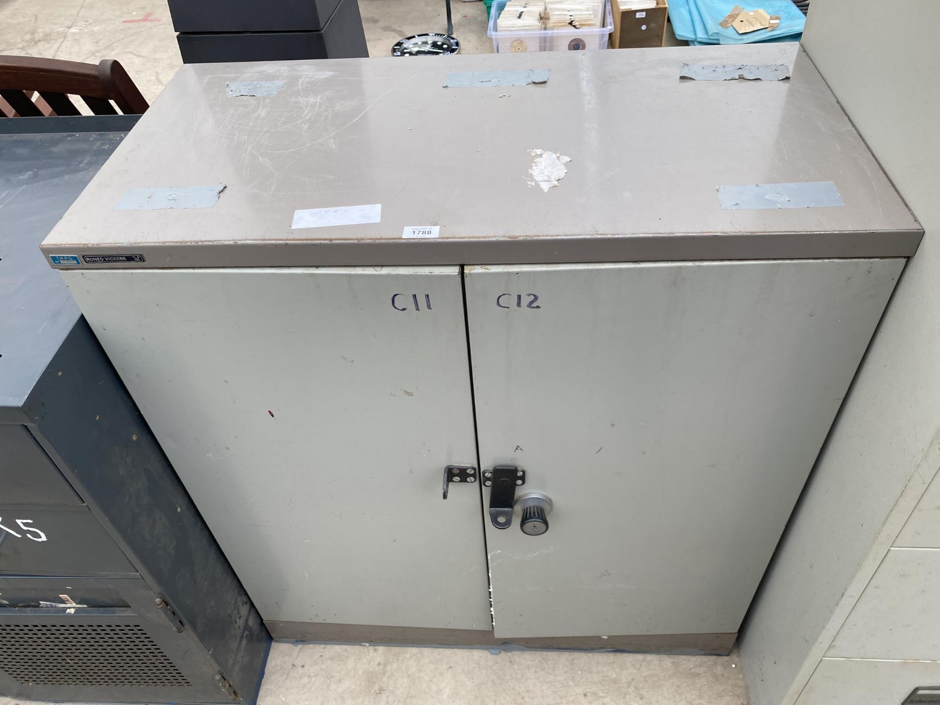 A RONEO VICKERS TWO DOOR METAL LOCKABLE CUPBOARD