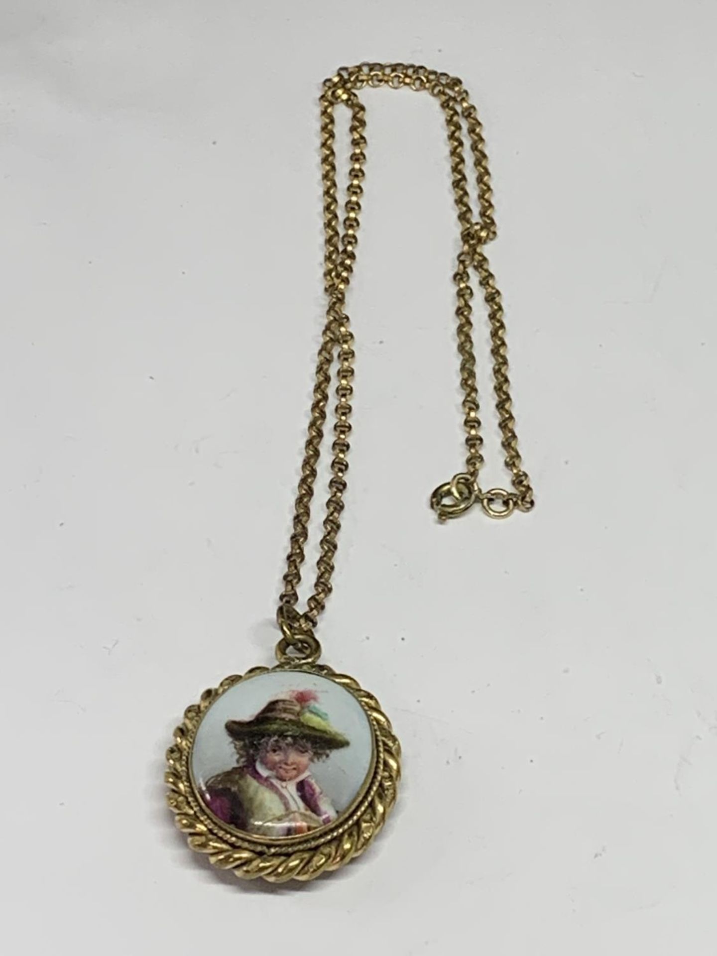 A VICTORIAN LOCKET WITH A CERAMIC FRONT WITH A PICTURE OF A YOUNG BOY
