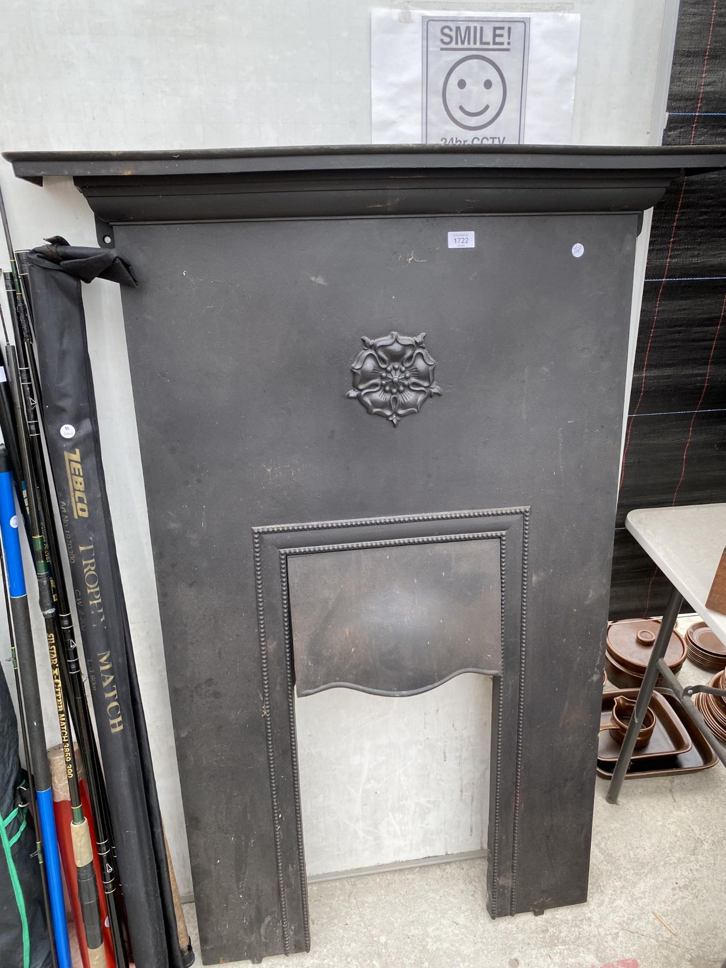 A DECORATIVE HEAVY CAST IRON FIRE SURROUND