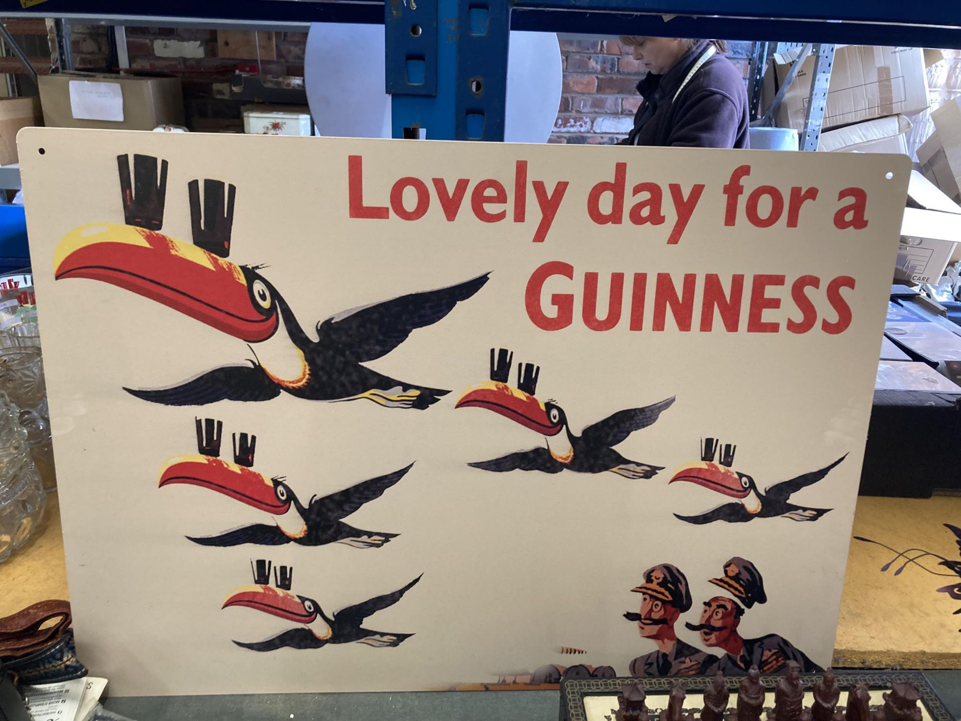 A TIN PLATE SIGN 'LOVELY DAY FOR A GUINNESS' 70CM X 50CM