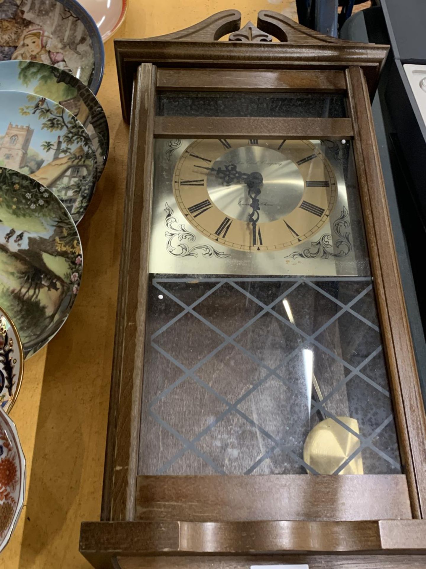 A VINTAGE STYLE MAHOGANY WALL CLOCK WITH PENDULUM