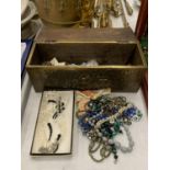 A QUANTITY OF COSTUME JEWELLERY IN BRASS AND WOODEN BOX