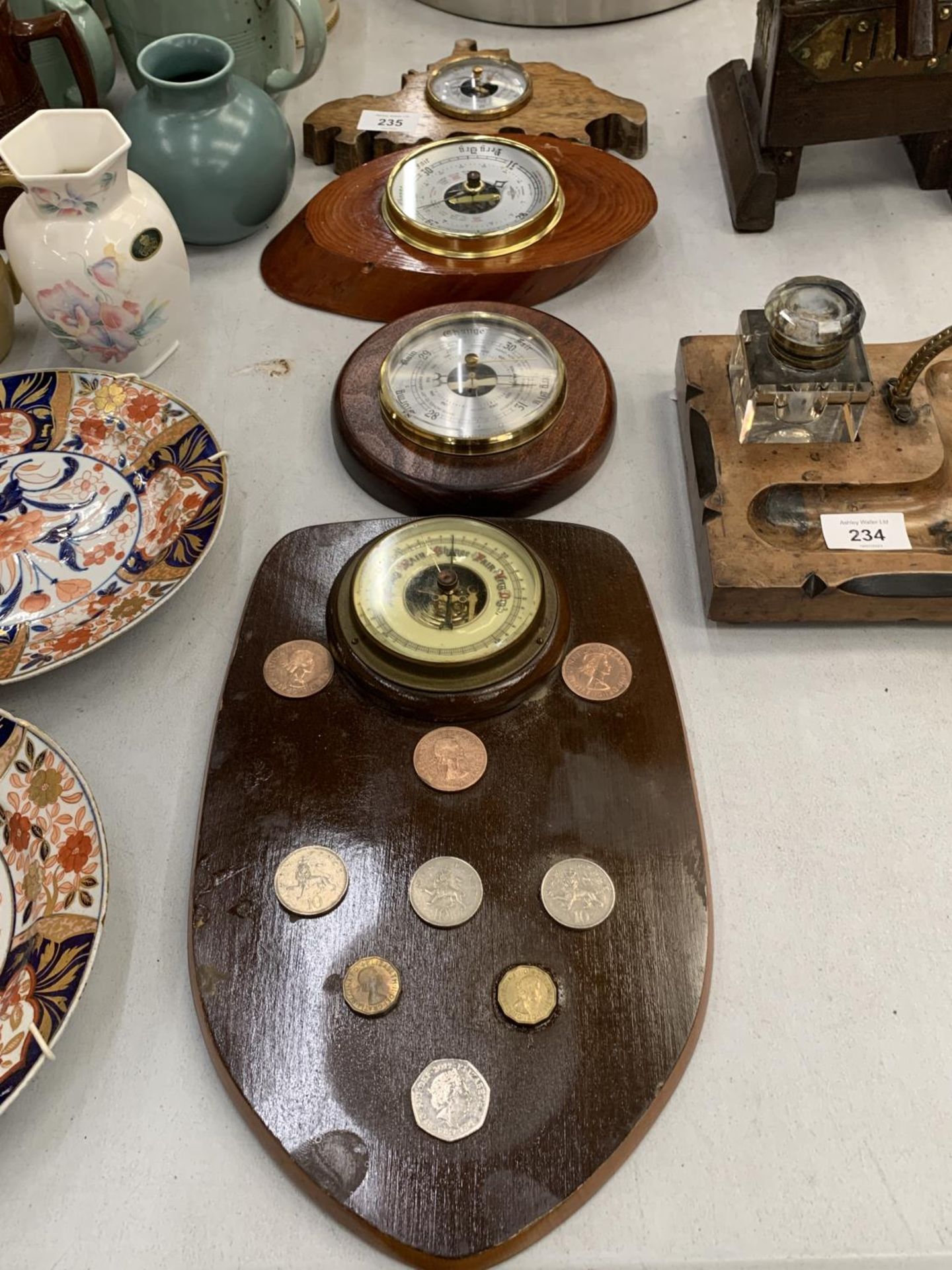 A BAROMETER DECORATED WITH BRITISH COINS TO INCLUDE NEW PENCE TOGETHER WITH A SMALL CIRCULAR