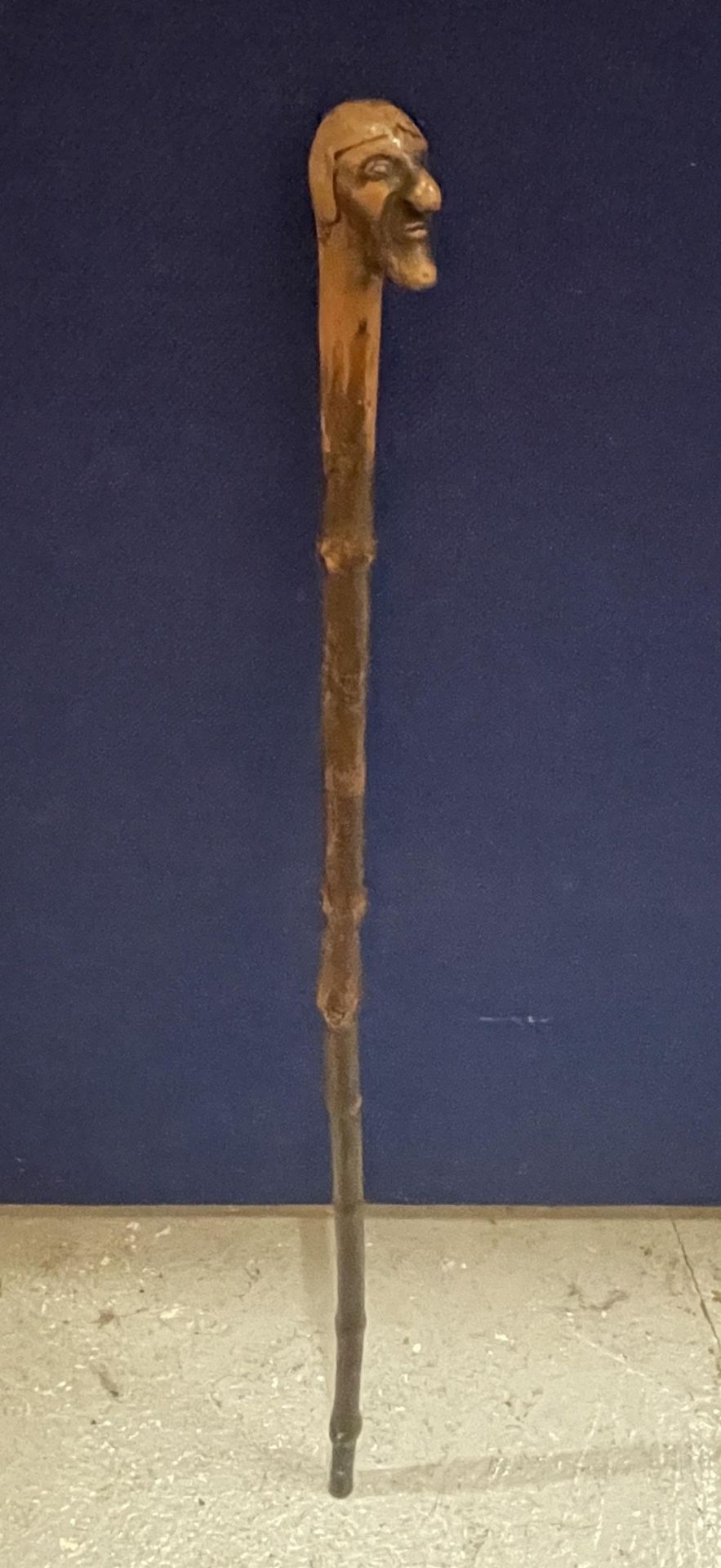 A VINTAGE WOODEN WALKING STICK WITH FIGURE HEAD DESIGN TOP