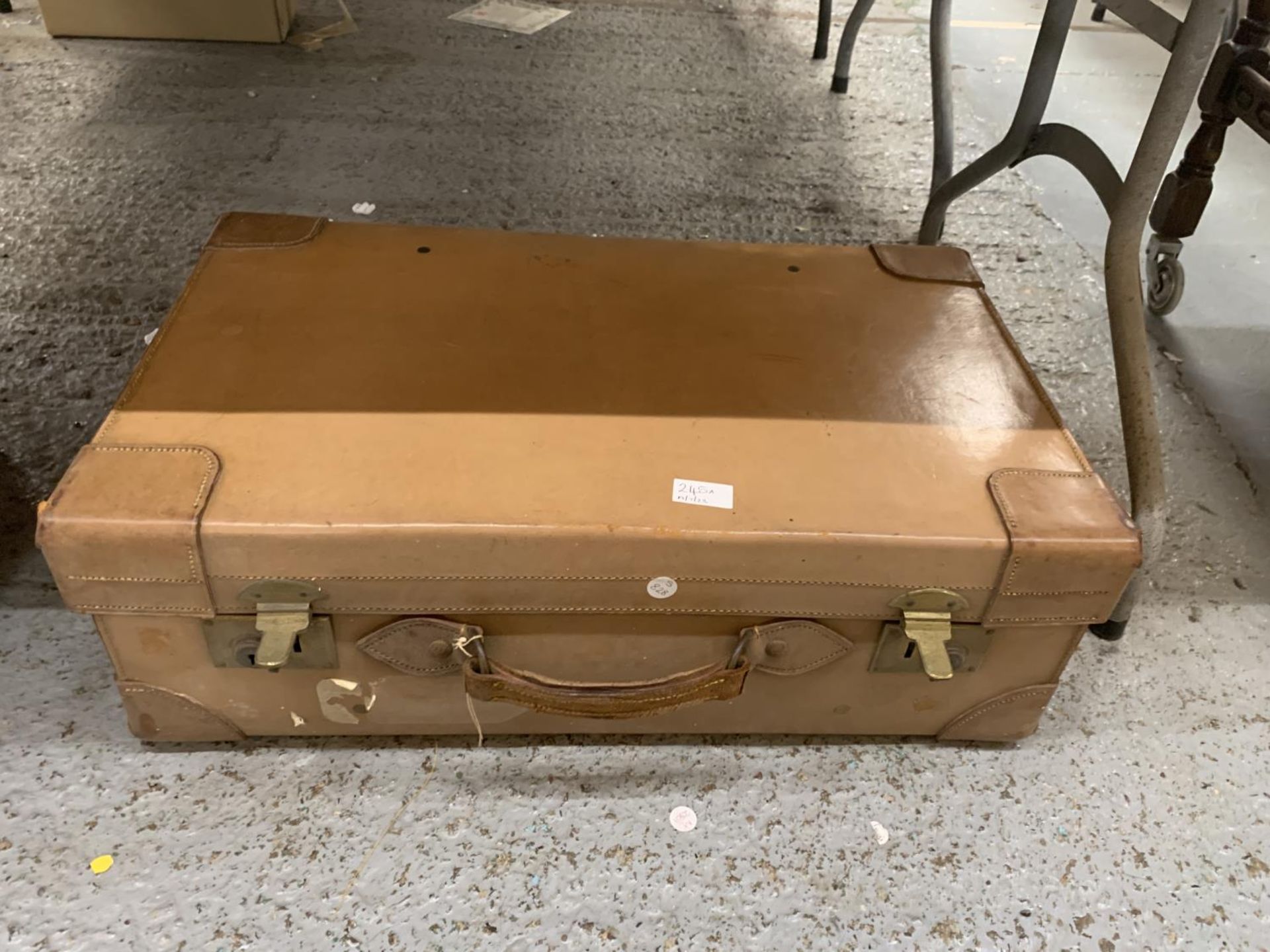 A VINTAGE LEATHER SUITCASE