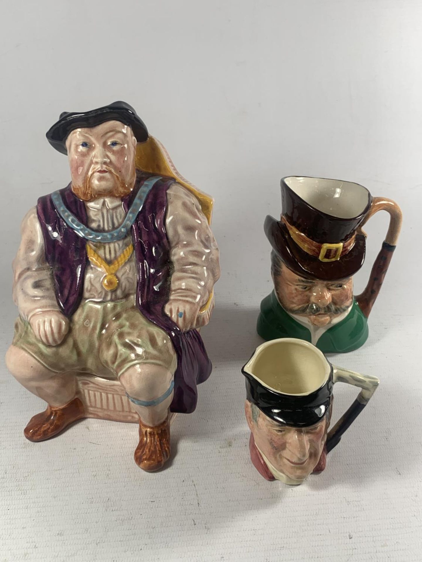 THREE VARIOUS SIZED TOBY JUGS