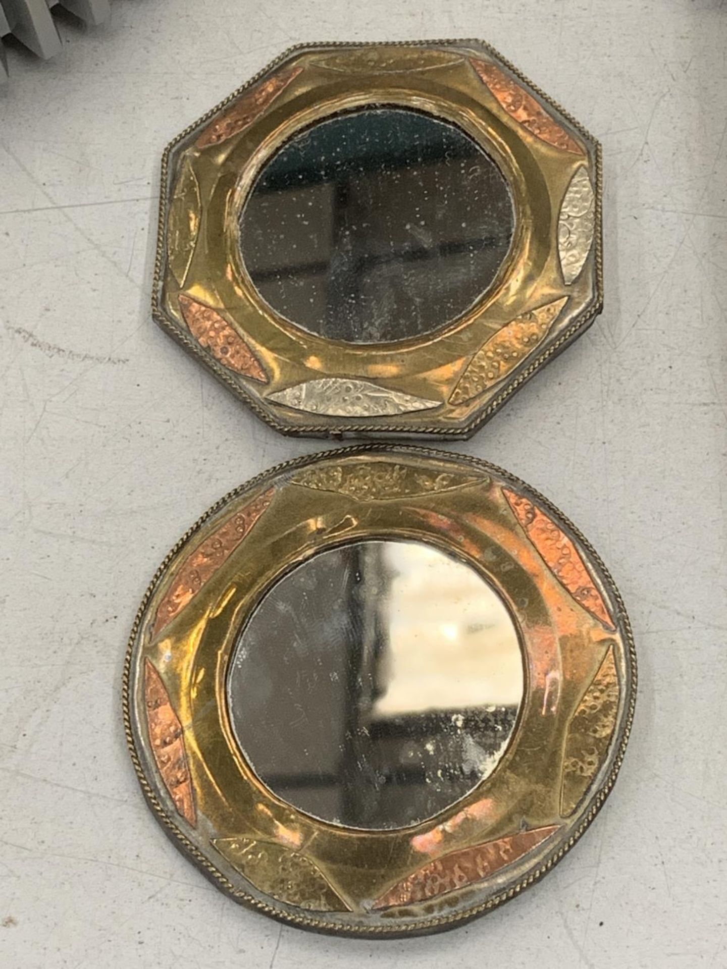 TWO BRASS AND COPPER MIRRORS