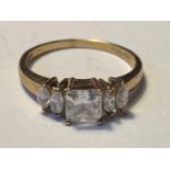 A 9 CARAT GOLD RING WITH CENTRE SQUARE CUBIC ZIRCONIA AND TWO EACH SIDE ON THE SHOULDERS SIZE N